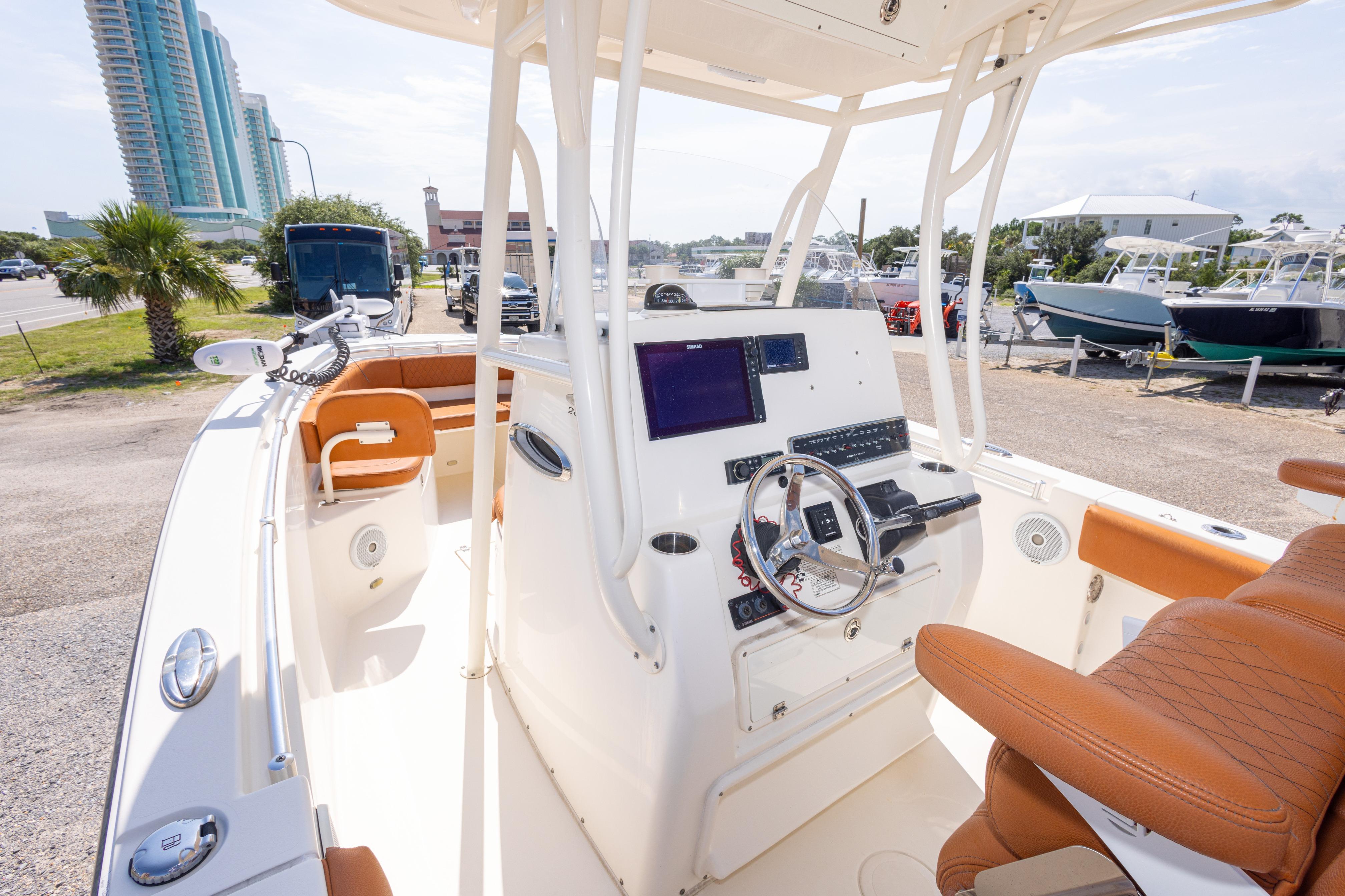 2017 Cobia 261 Center Console boat with modern helm, parked near marina.