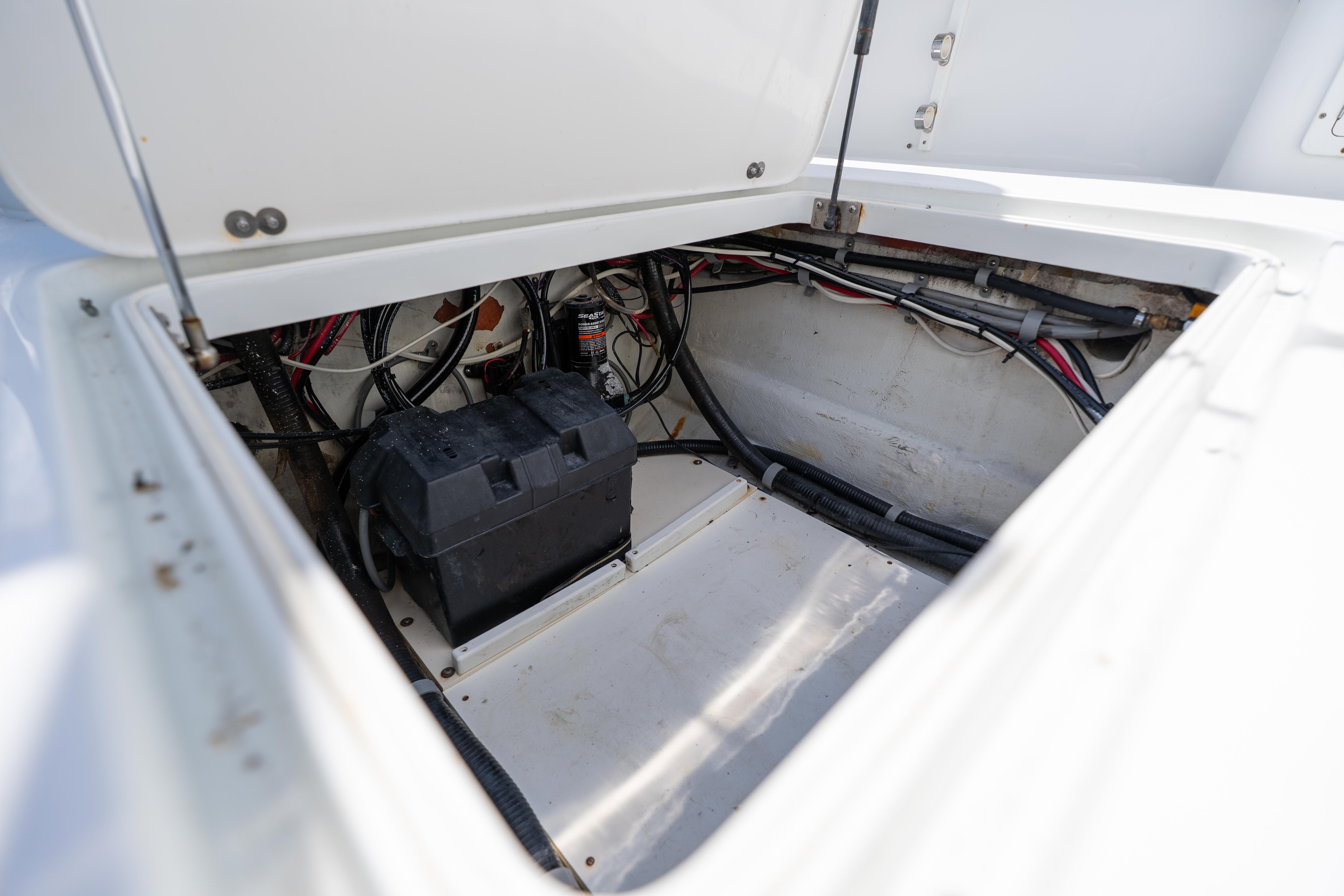 Open hatch of 2007 Yellowfin 34 Offshore boat showing battery and wiring.