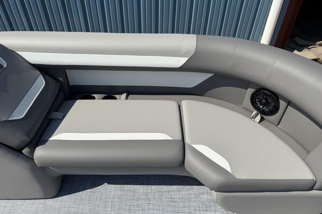 Luxurious seating on 2026 Premier 220 Sunscape RF boat with cup holders and speaker.