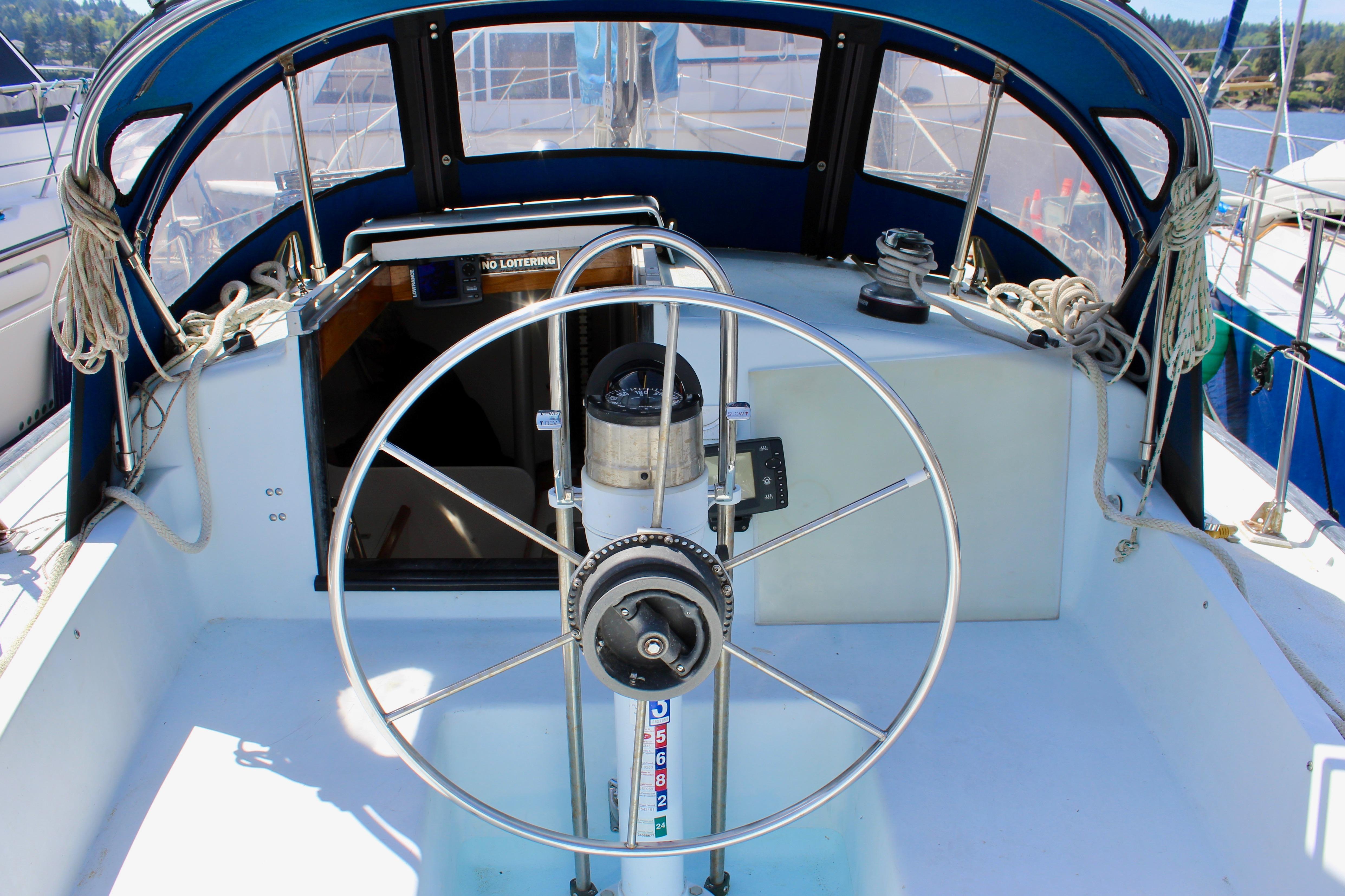 Cockpit of 1993 Freya 39 sailboat with steering wheel and nautical equipment.