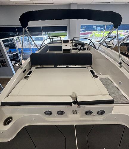 2024 Bayliner DX 2050 boat interior with seating and canopy.