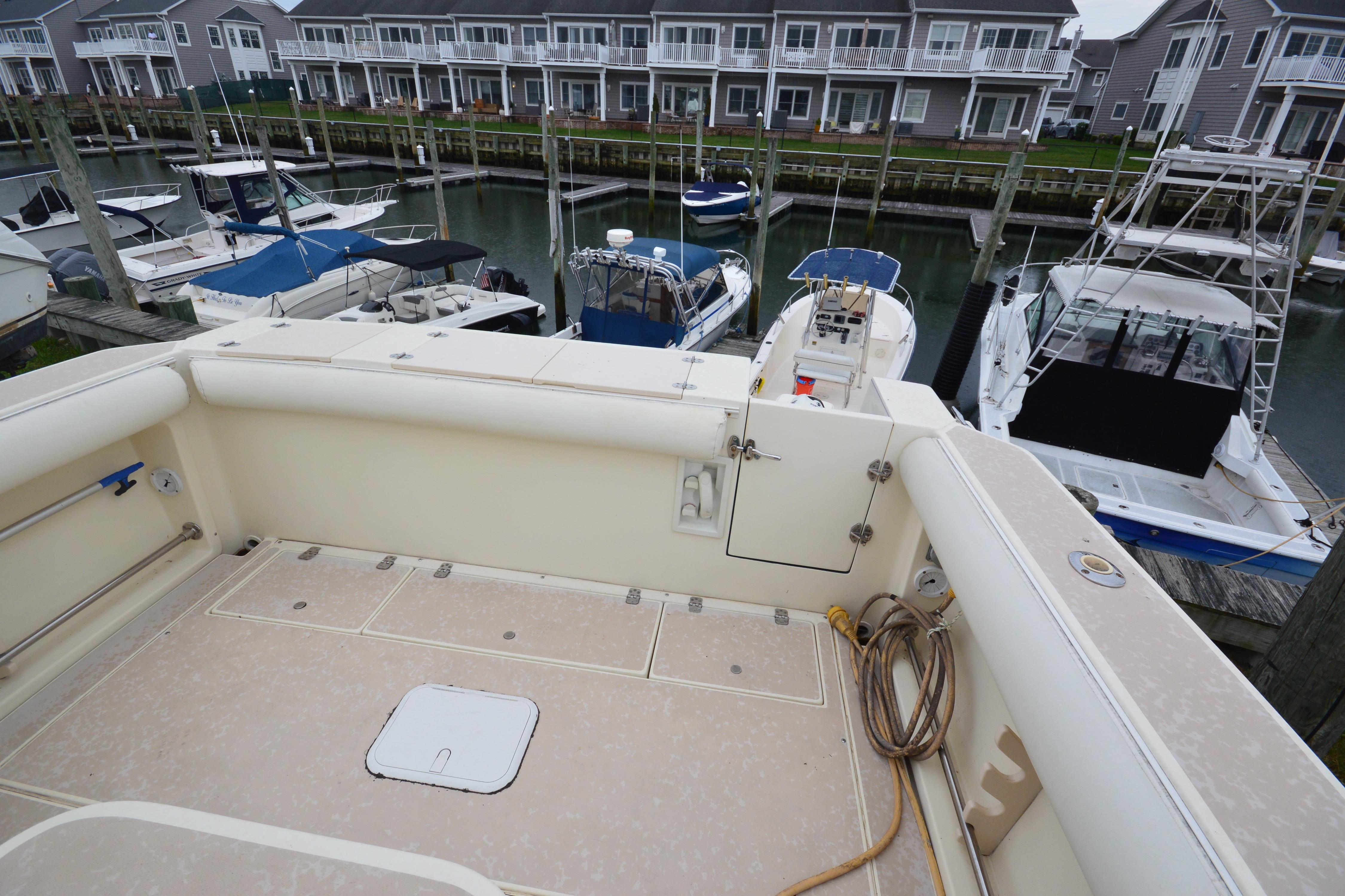 2001 Albin 28 Tournament Express docked in a marina with other boats nearby.