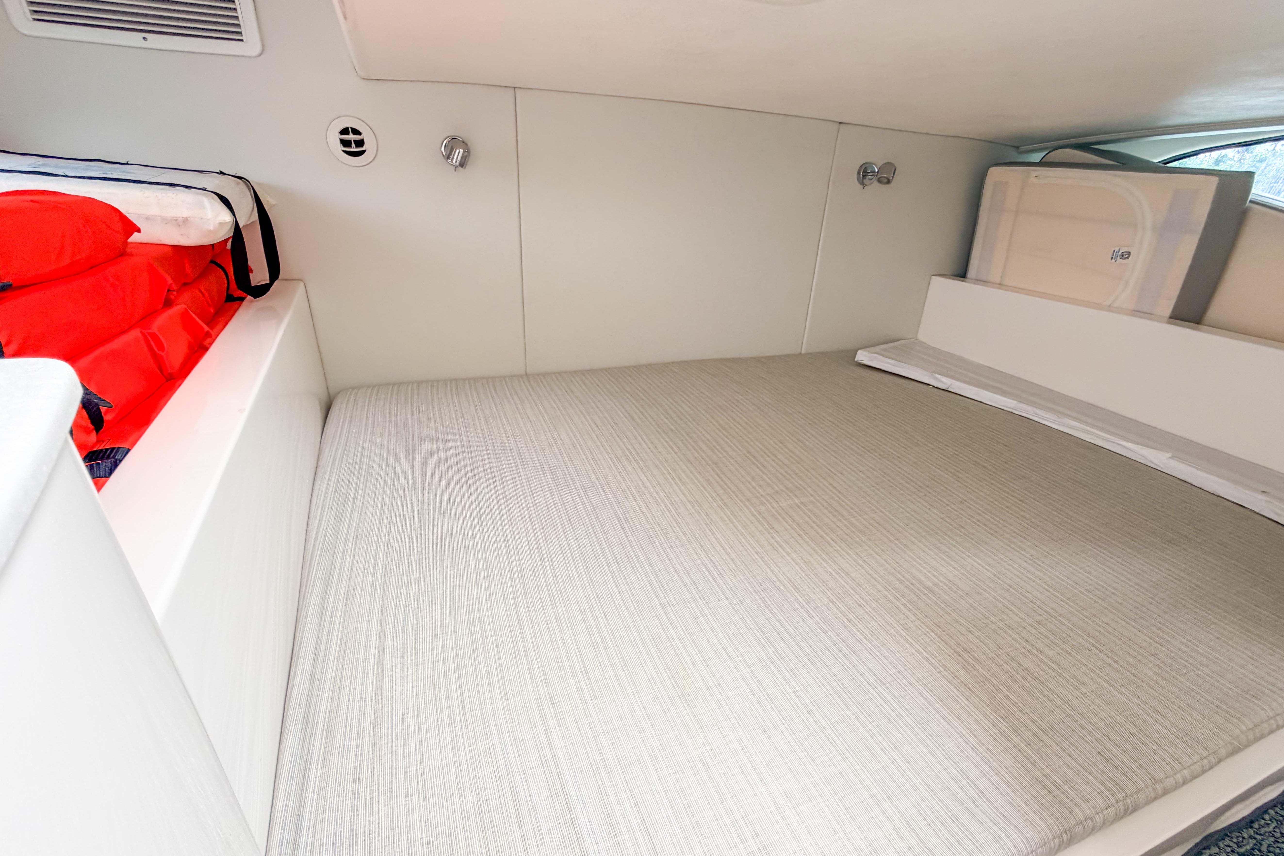 2021 Intrepid 409 Valor cabin interior with bed and life jackets.