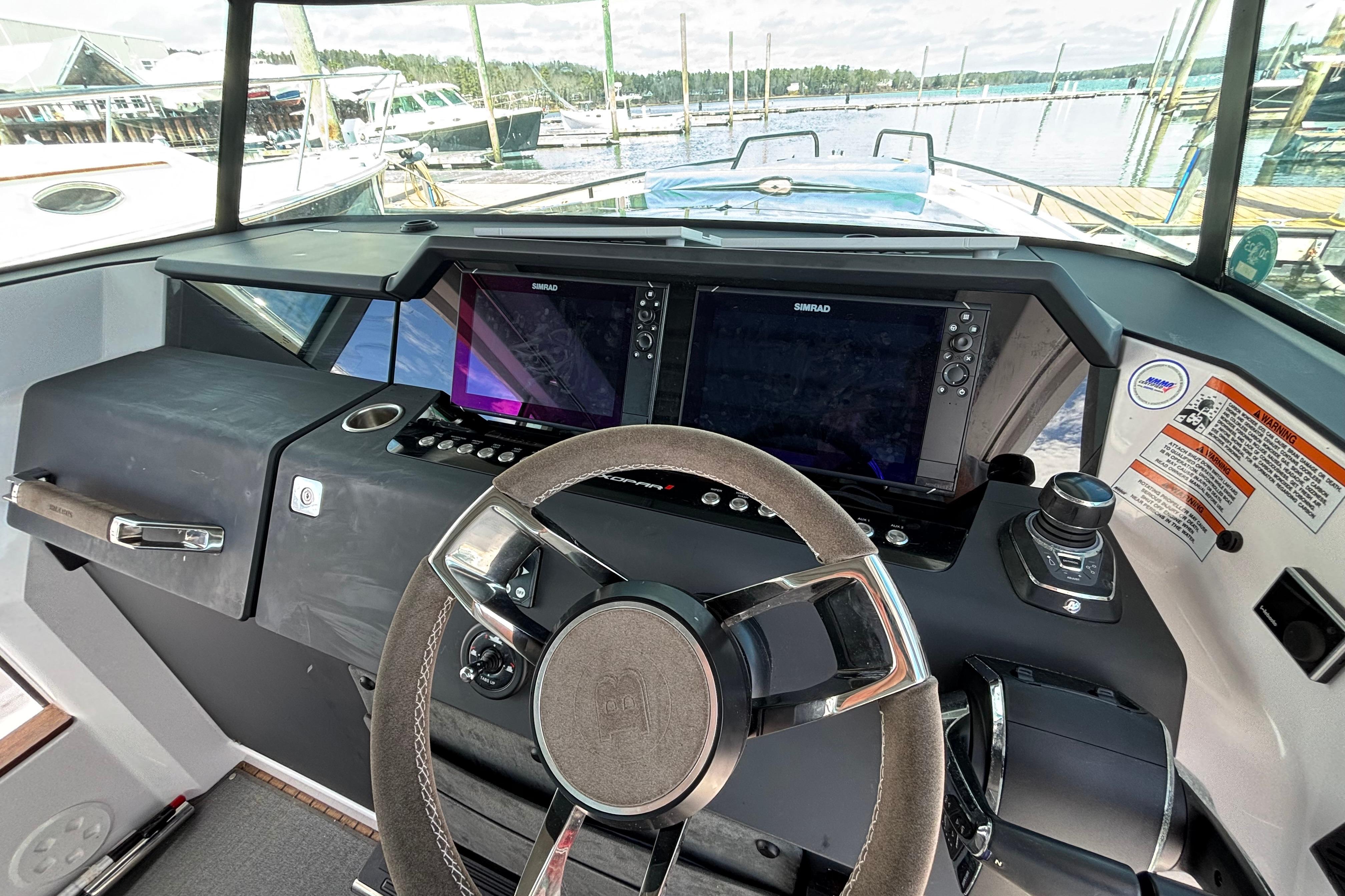 2024 Axopar 37 XC Cross Cabin helm with modern navigation displays and steering wheel.