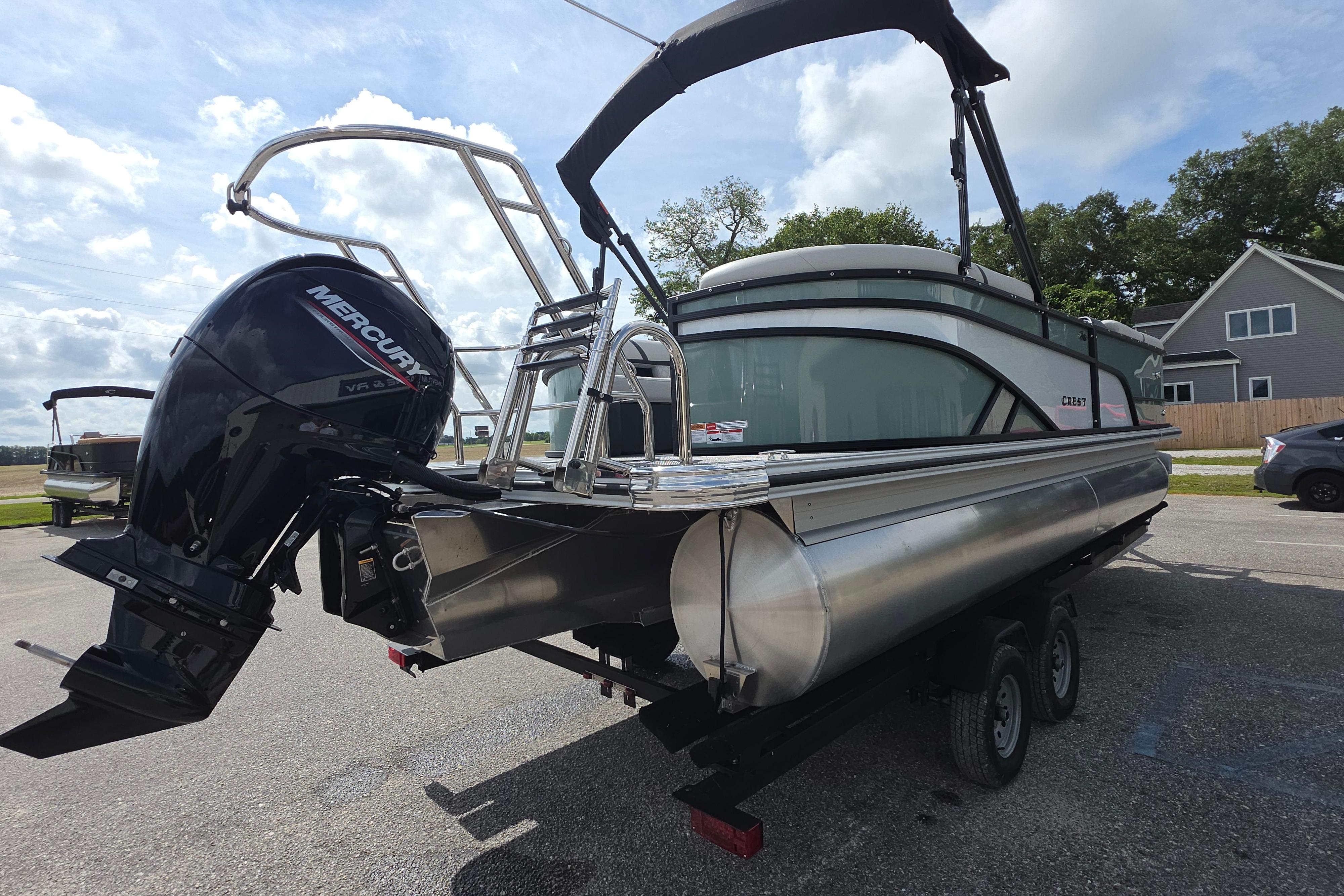 2026 Crest 235 Conquest SLC pontoon boat with Mercury outboard motor on trailer.