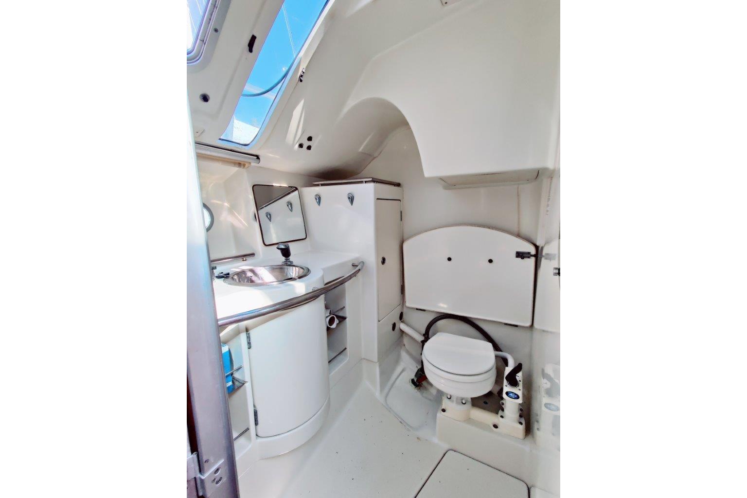 Interior of 1991 Beneteau First 38s5 yacht bathroom with sink and toilet.