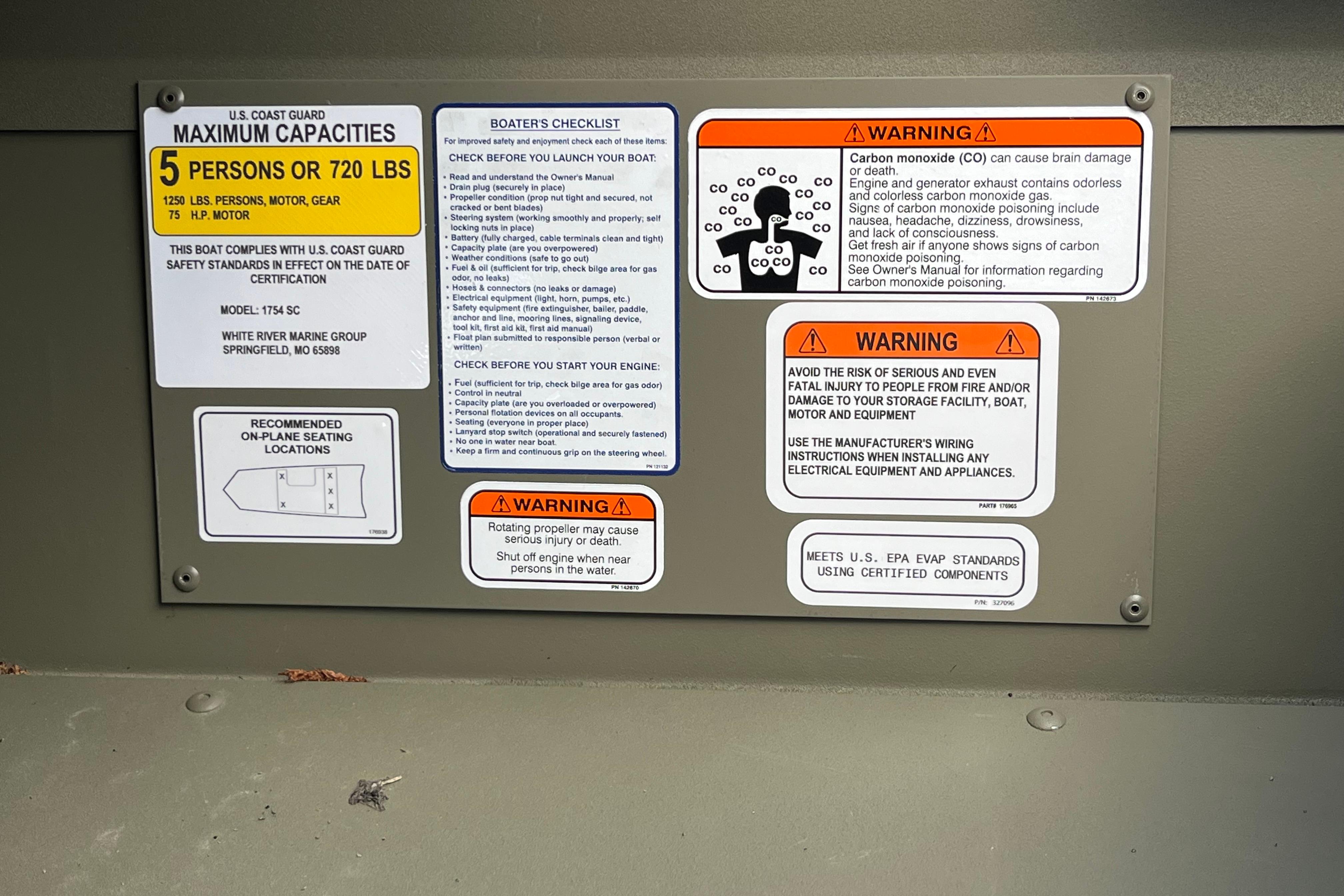 Safety and warning labels on a 2026 Tracker Grizzly 1754 SC boat.