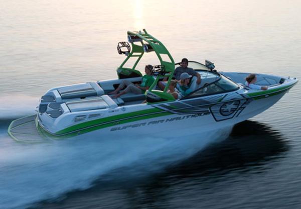 Manufacturer Provided Image: 2013 Nautique Super Air Nautique 230 speedboat cruising on water with passengers.