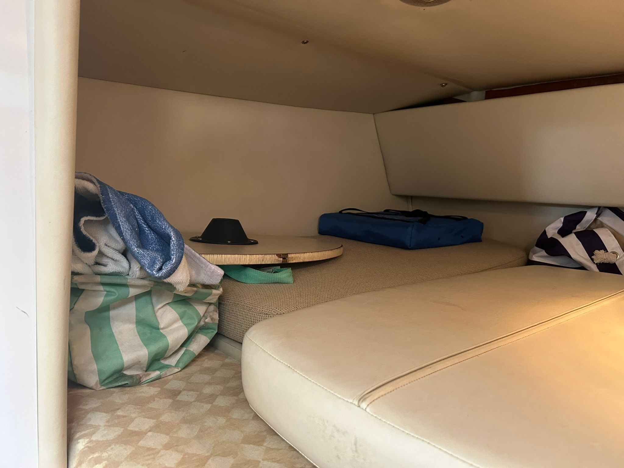 Interior of a cabin with cushions and blankets.