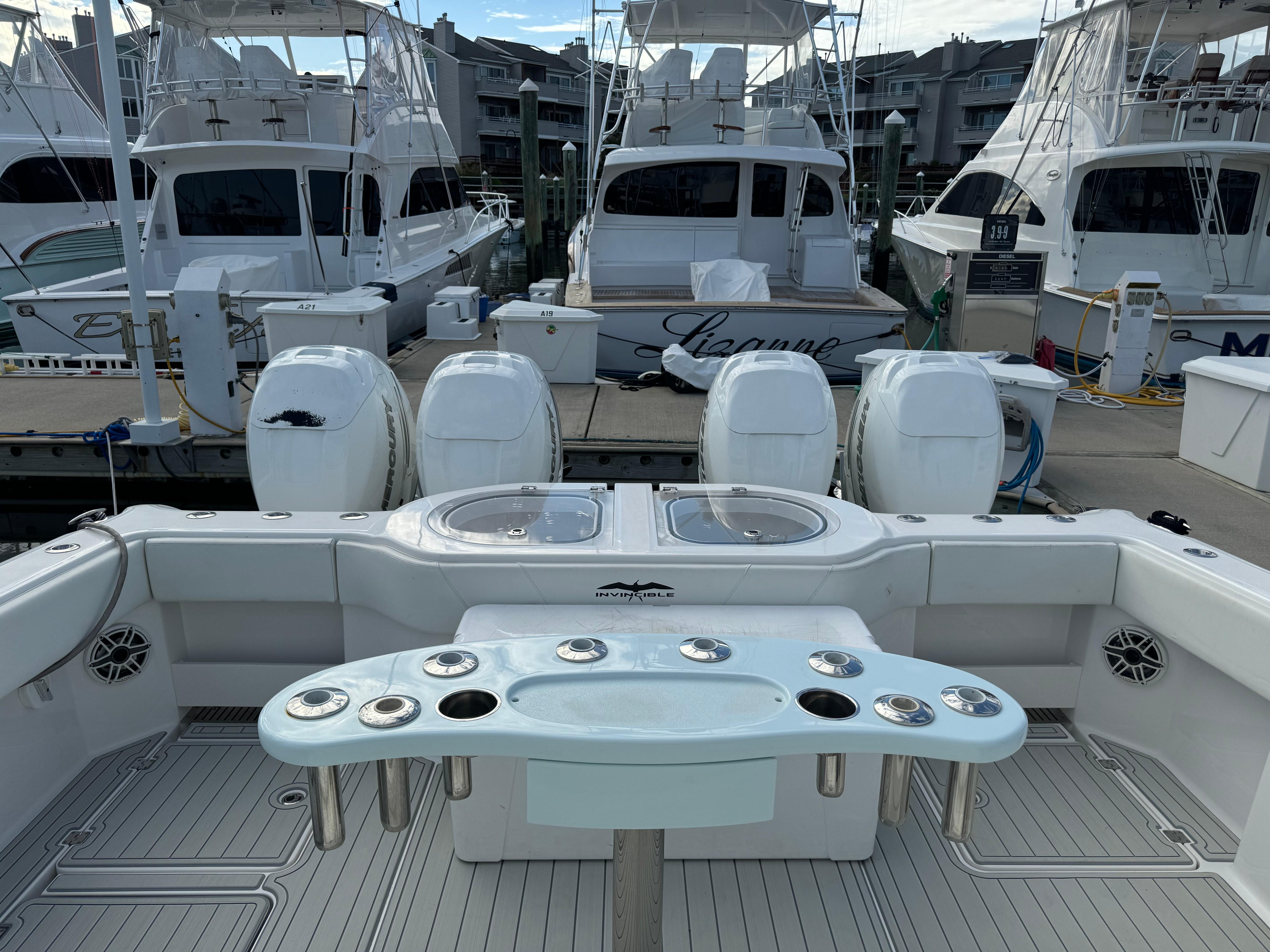 Invincible 40 Catamaran 2020 docked with multiple outboard engines and fishing setup.