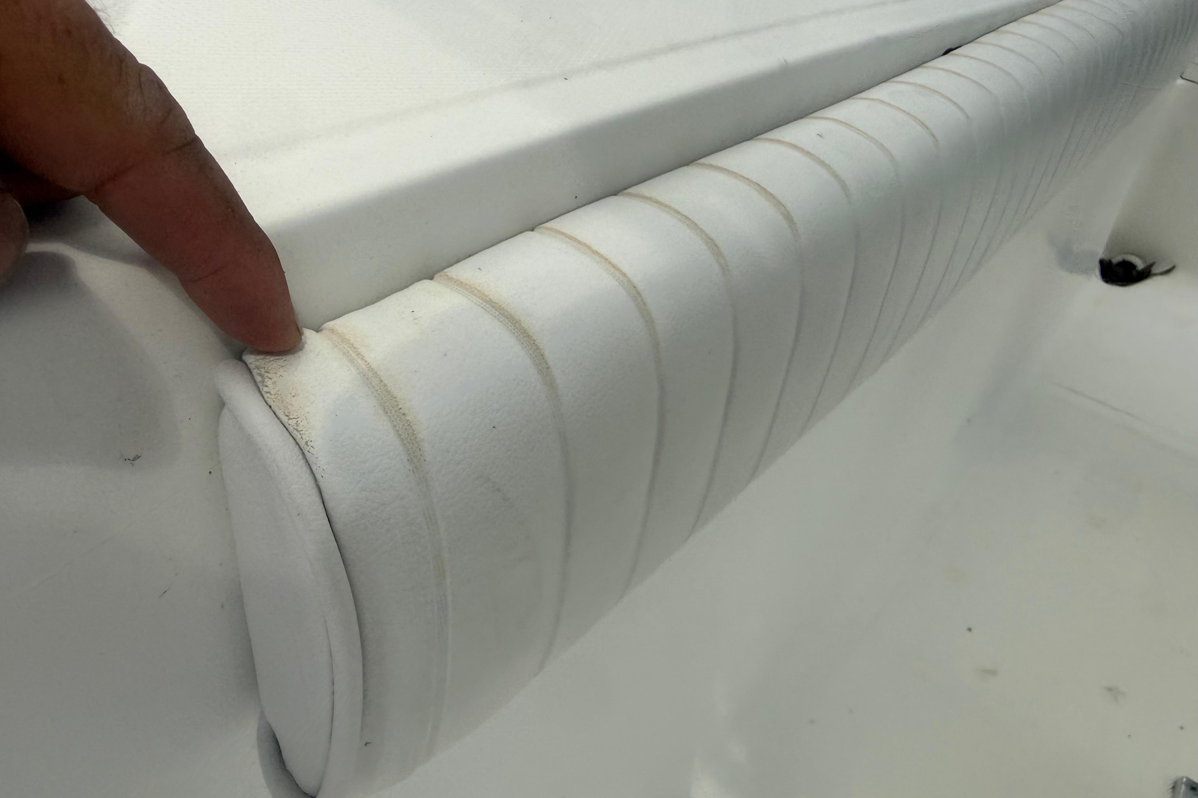 Close-up of a 2012 Clearwater 2000 Center Console boat's cushioned seating detail.
