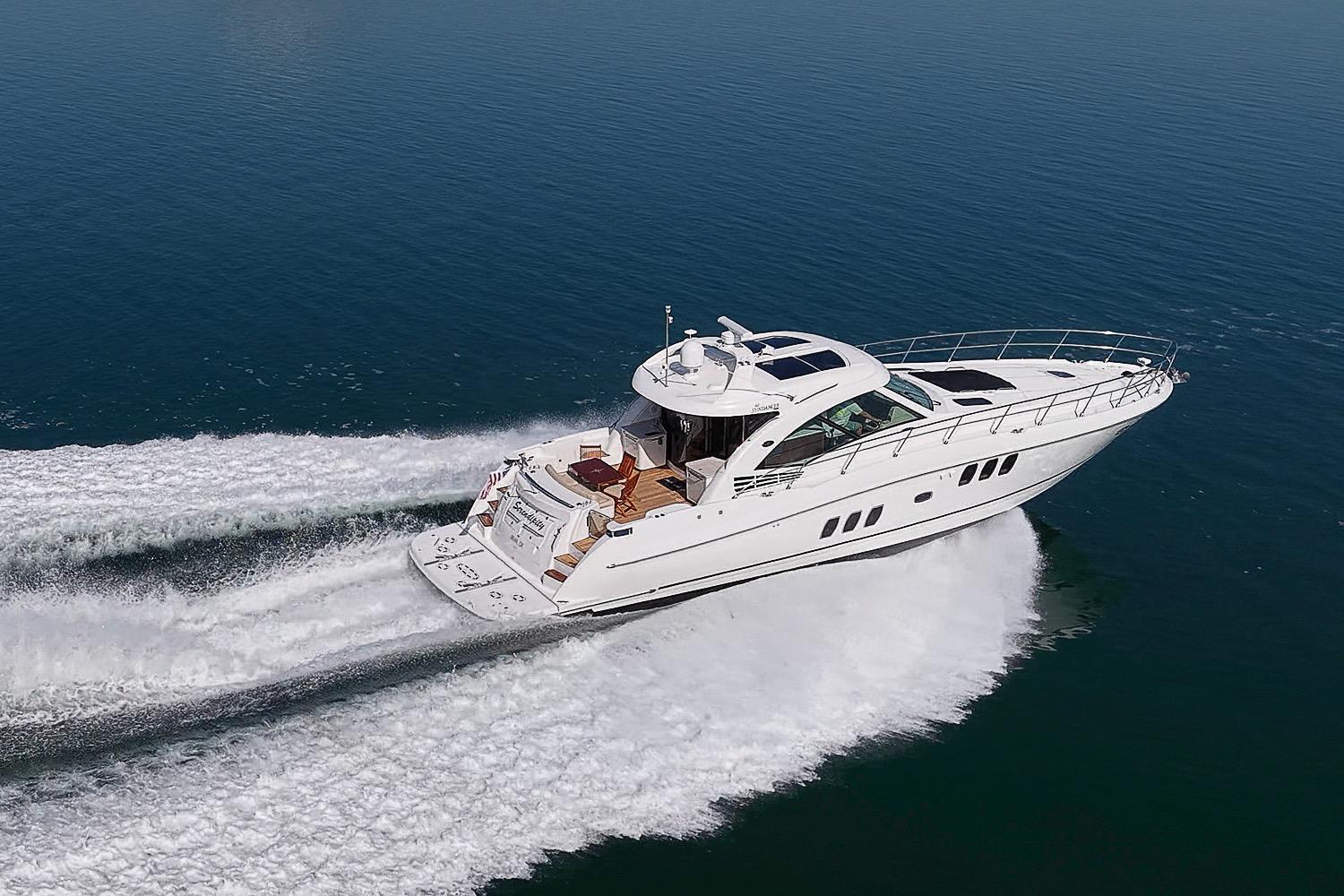 2008 Sea Ray 60 Sundancer yacht cruising on open water, showcasing sleek design and performance.