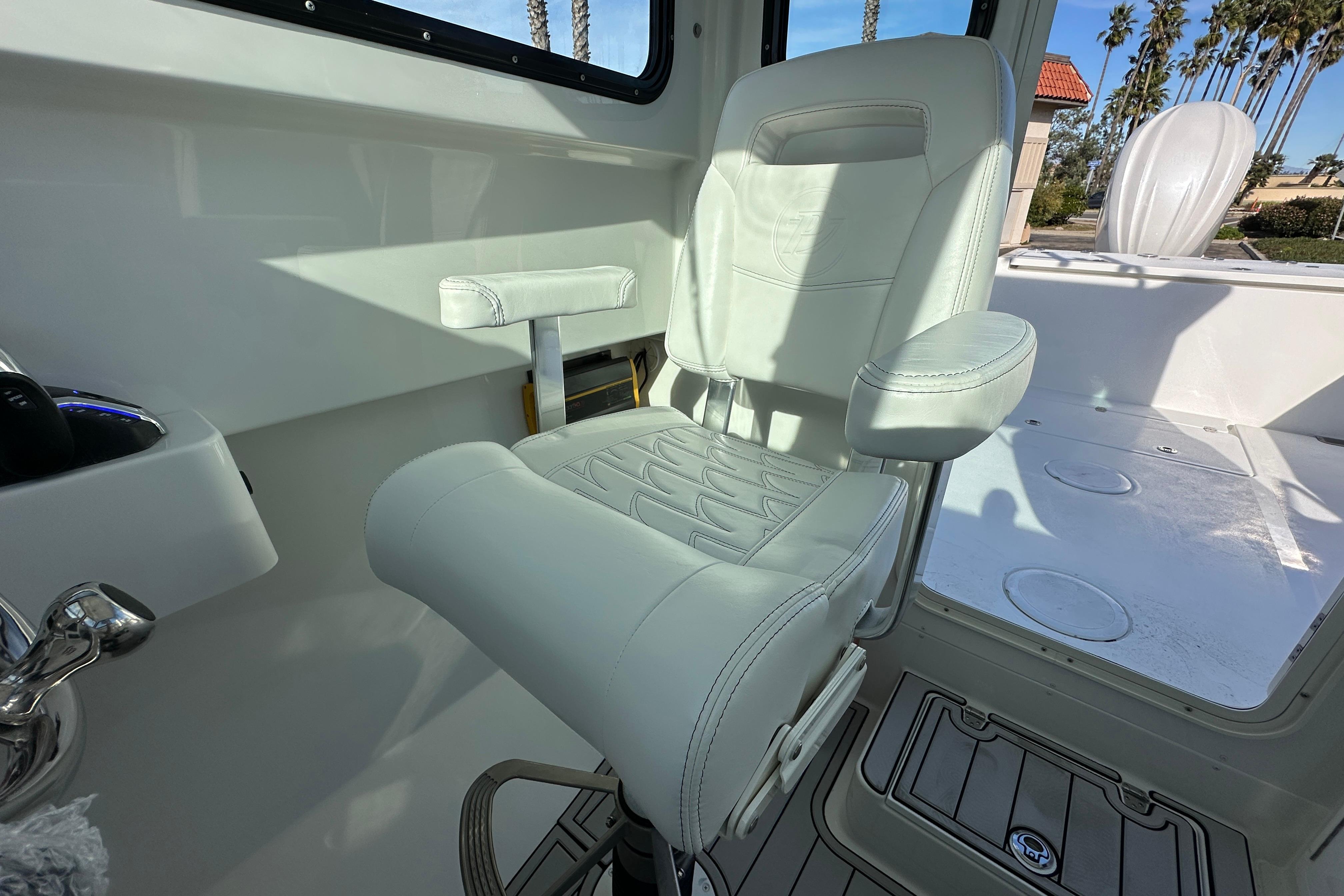 Luxurious seating on 2026 Parker 227 Explorer boat, featuring white leather upholstery and armrests.