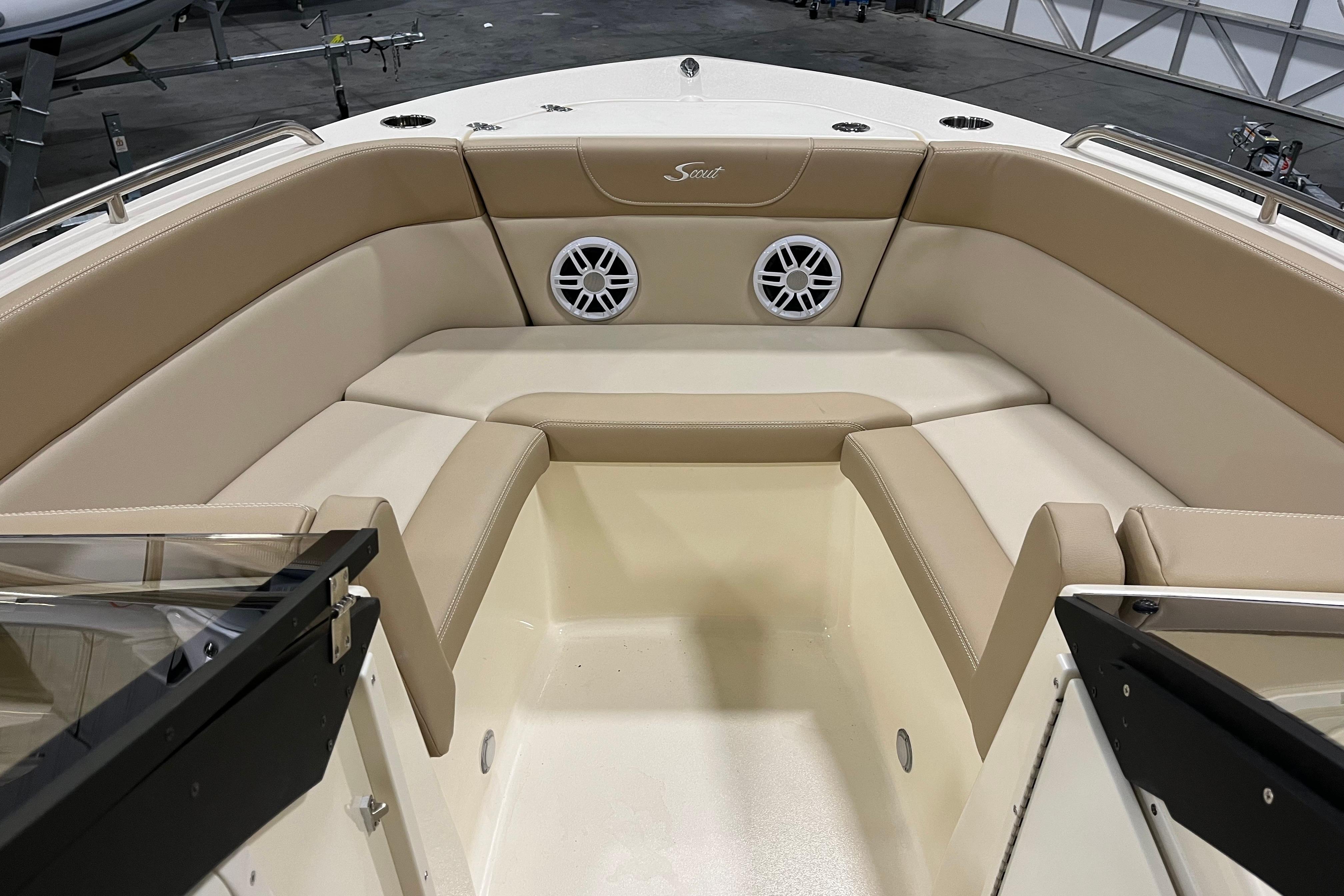 2025 Scout 215 Dorado boat interior with beige seating and built-in speakers.