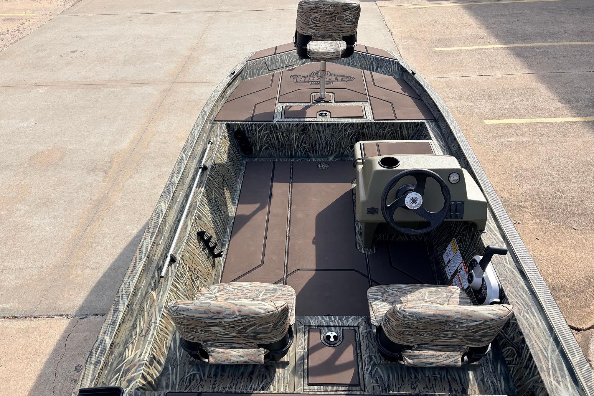2026 Tracker Grizzly 1754 SC boat with camo seats and steering console.