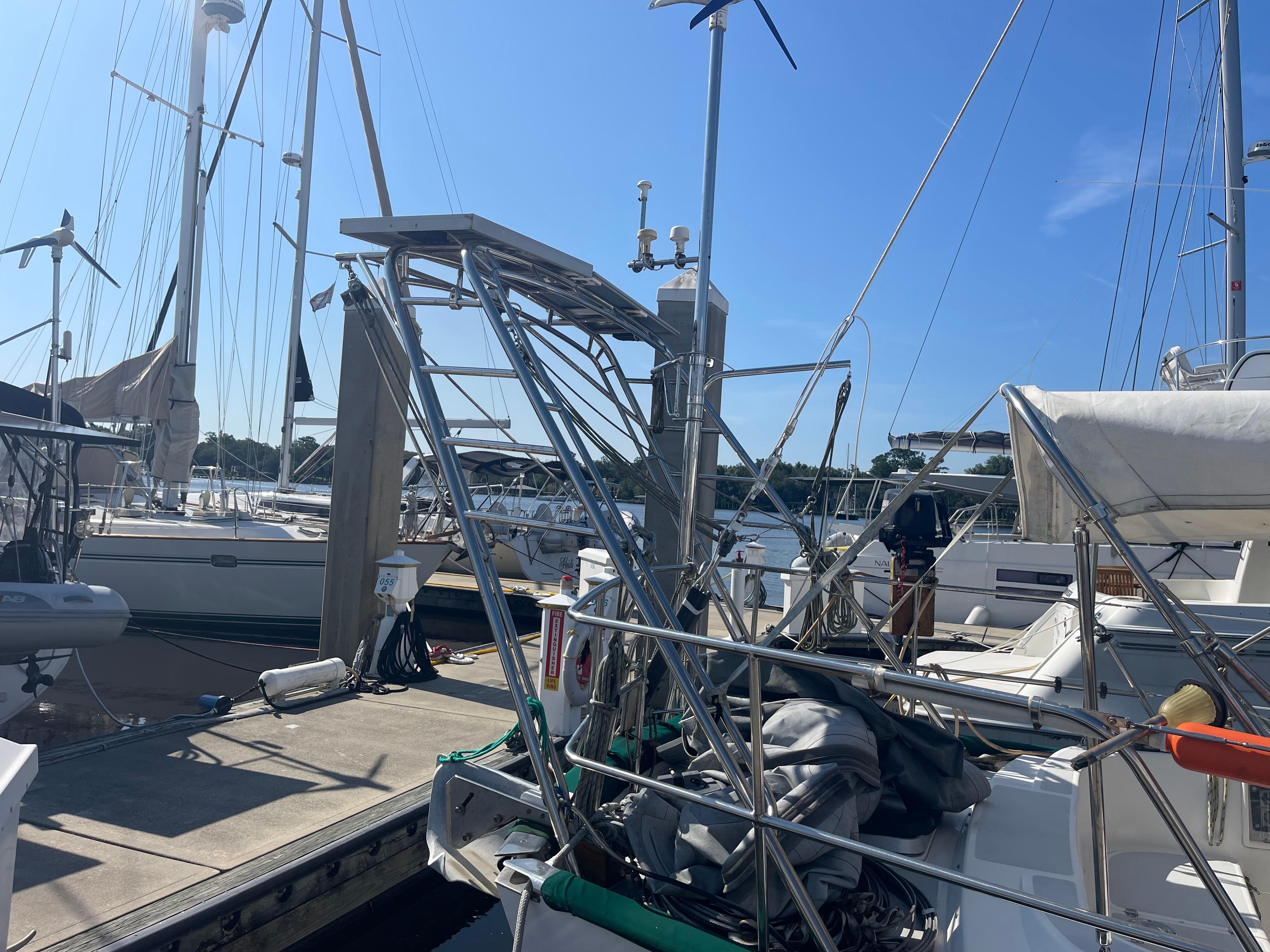Alt text: 1995 Passport 47 AC Plan B sailboat docked at marina on a sunny day.