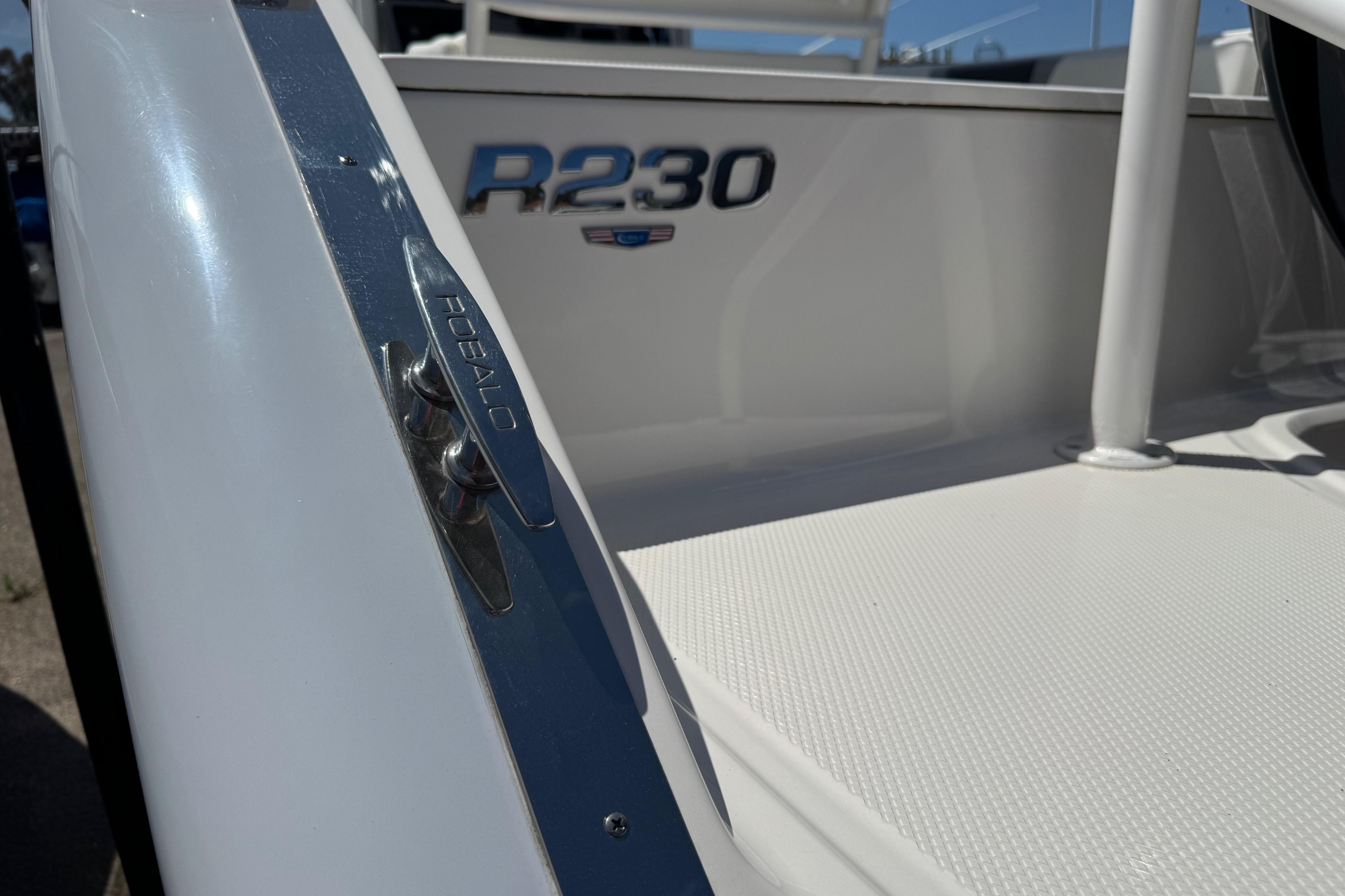 2022 Robalo R230 Center Console boat, close-up of deck and branding.