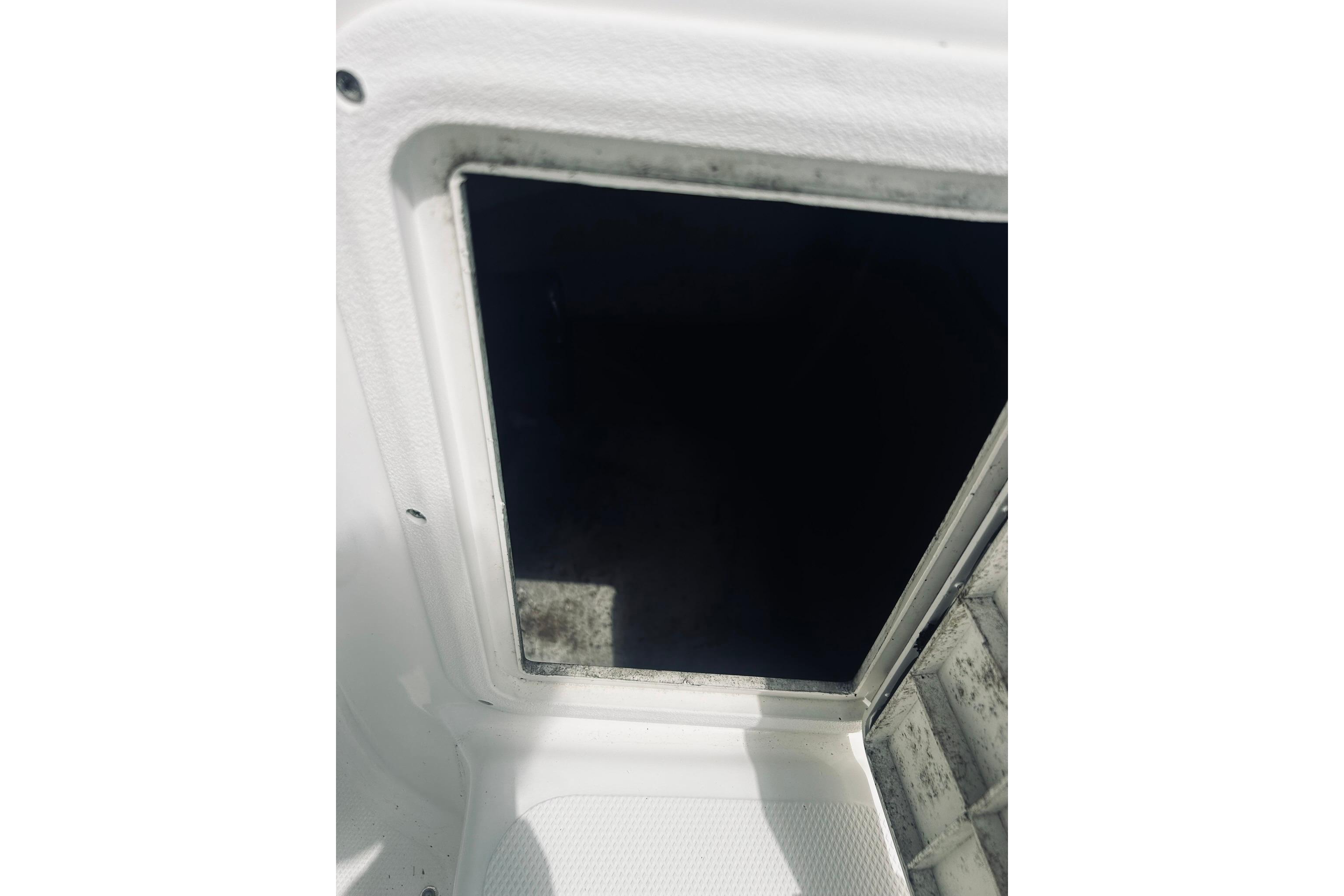Hatch opening on a 2013 Hurricane SunDeck Sport 201 OB boat.
