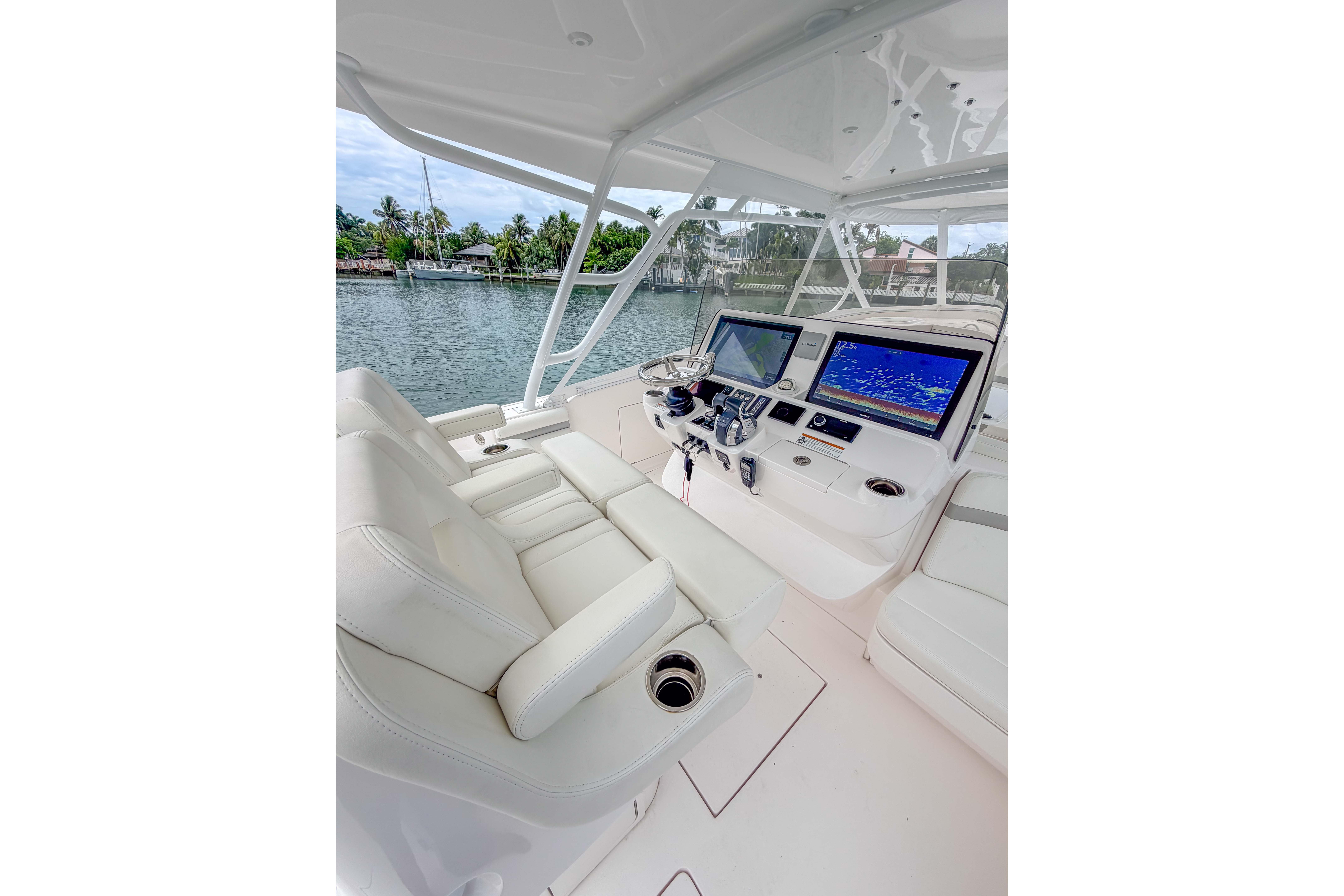 Luxurious 2021 Intrepid 409 Valor yacht cockpit with advanced navigation displays.