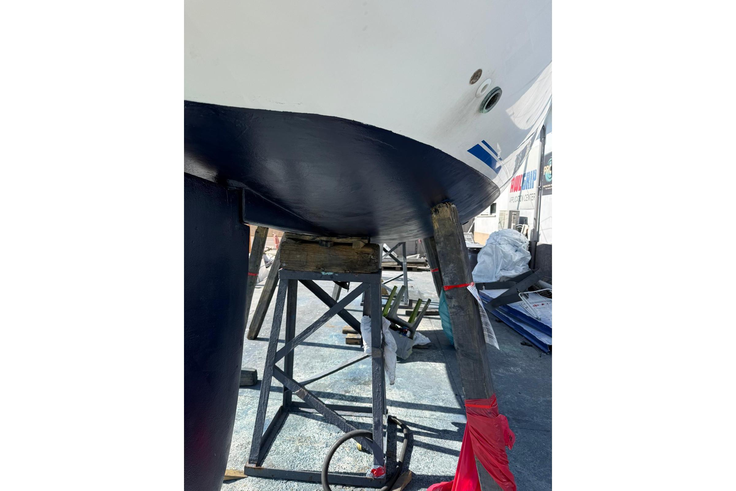 Ronautica RO 300 sailboat hull on stands, undergoing maintenance, 2000 model.