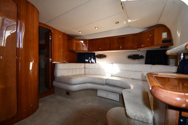 Luxurious interior of 1997 Sunseeker Camargue 47 yacht with elegant wood finishes and plush seating.
