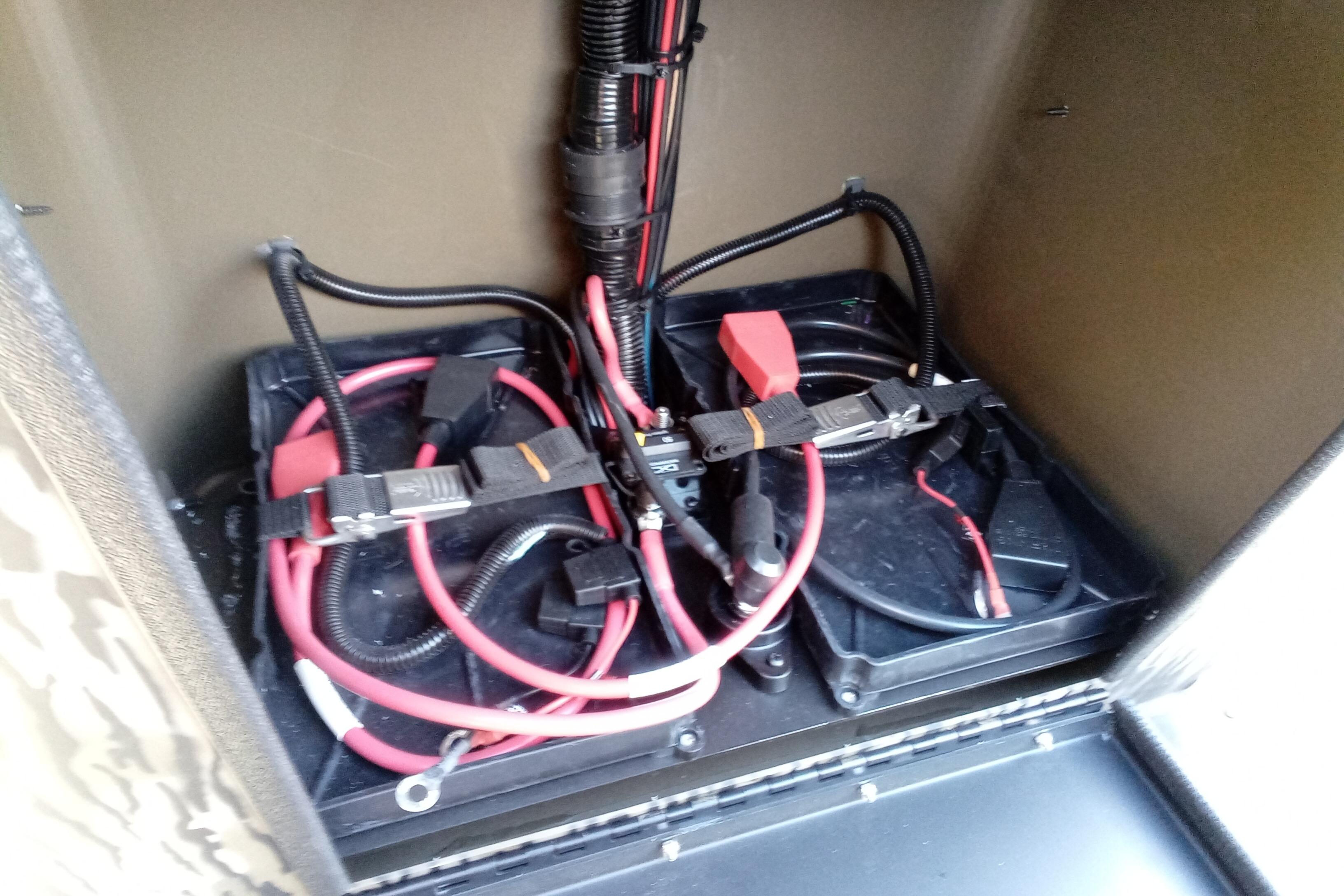 Battery compartment of 2026 Thor 1900 Low Country Elite with cables and connectors.