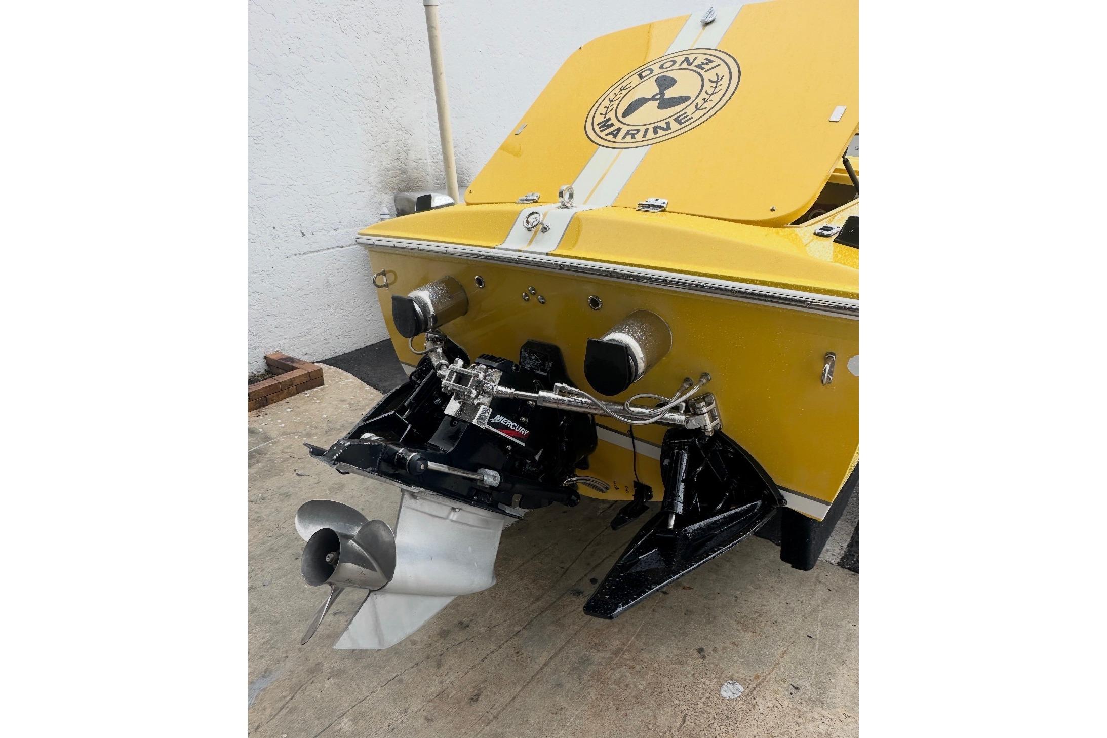 Yellow 2004 Donzi 22 Classic boat with Mercury outdrive, rear view.