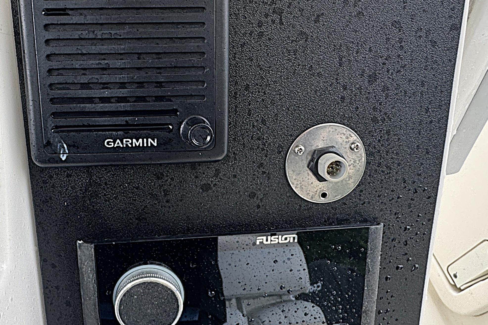 Control panel of a 2014 Boston Whaler 250 Outrage with Garmin and Fusion devices.