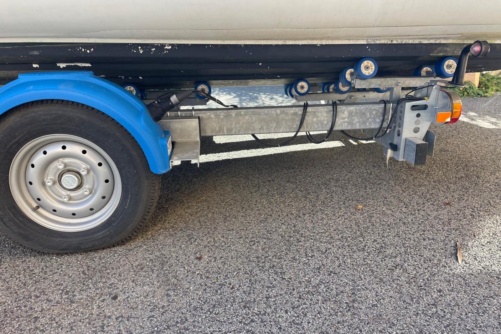 Trailer for 2022 Brig Eagle 6.7 boat, featuring blue wheel fender and metal frame.