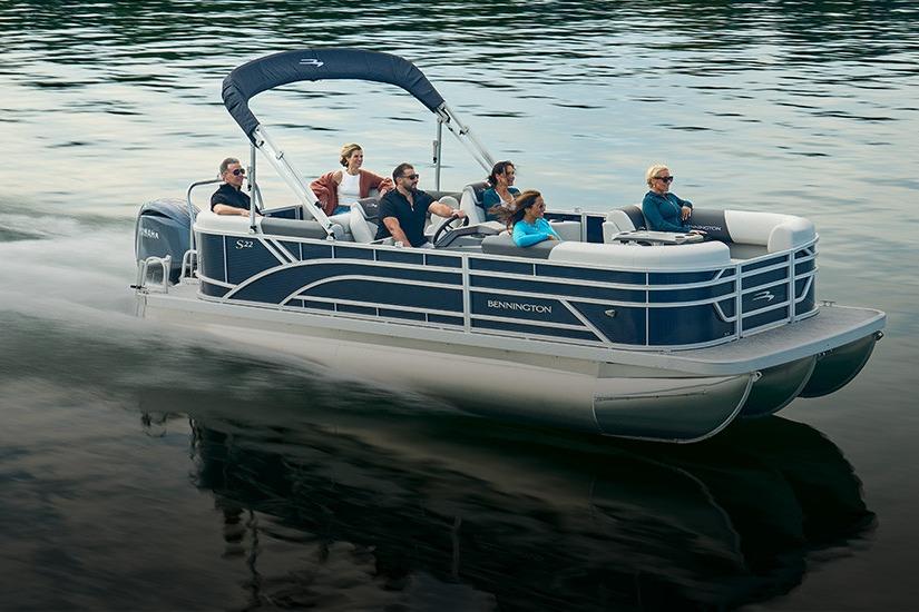 2026 Bennington 22 S-One Quad Bench pontoon boat cruising on a calm lake.