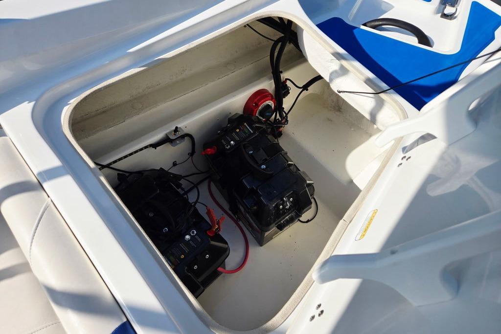 Open battery compartment of 2018 Tahoe 450 TS boat, showing dual batteries and wiring.