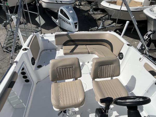 2022 Hurricane Center Console SS 231 OB boat interior with beige seating and steering wheel.