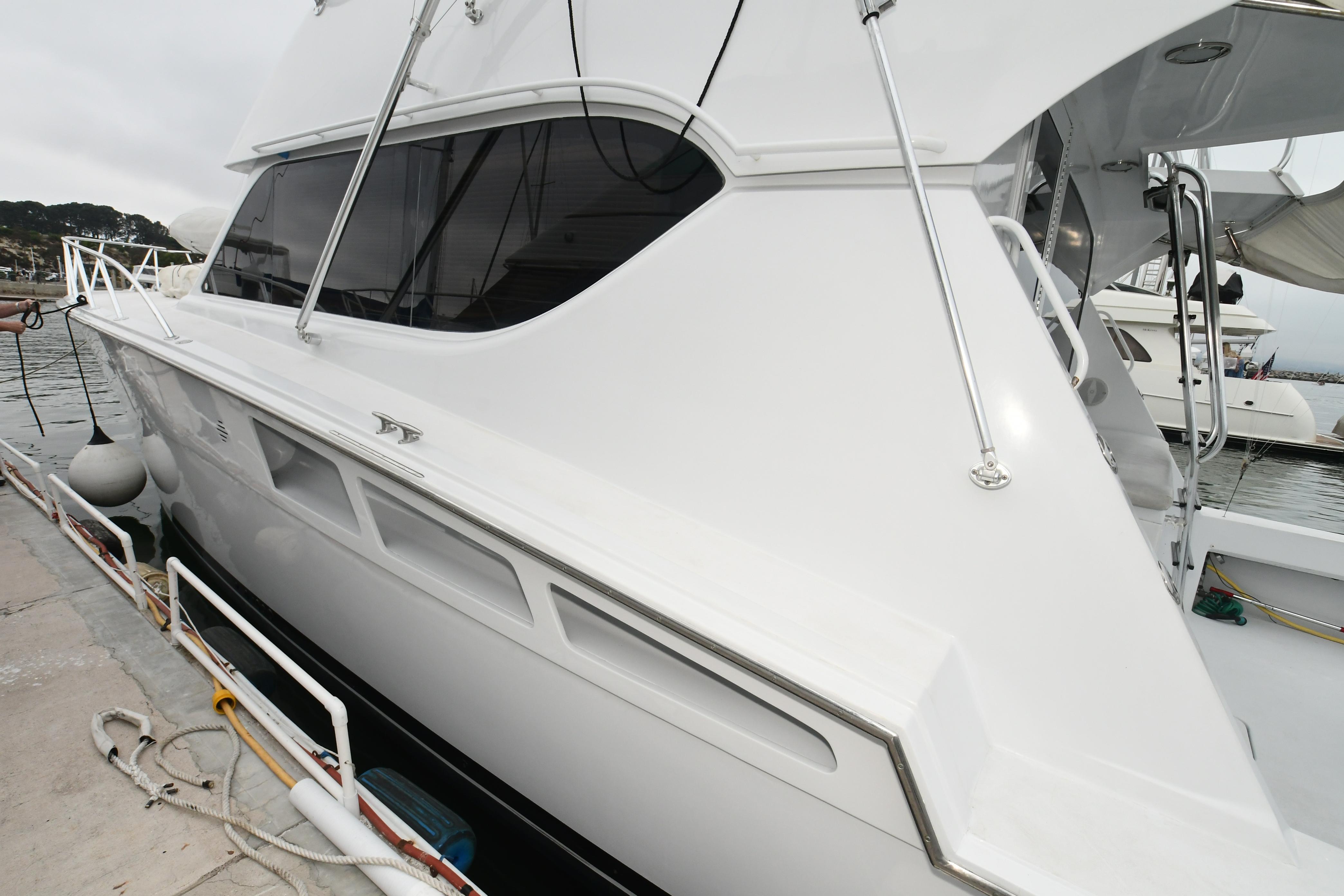 2001 Hatteras 50 Convertible yacht docked, side view.