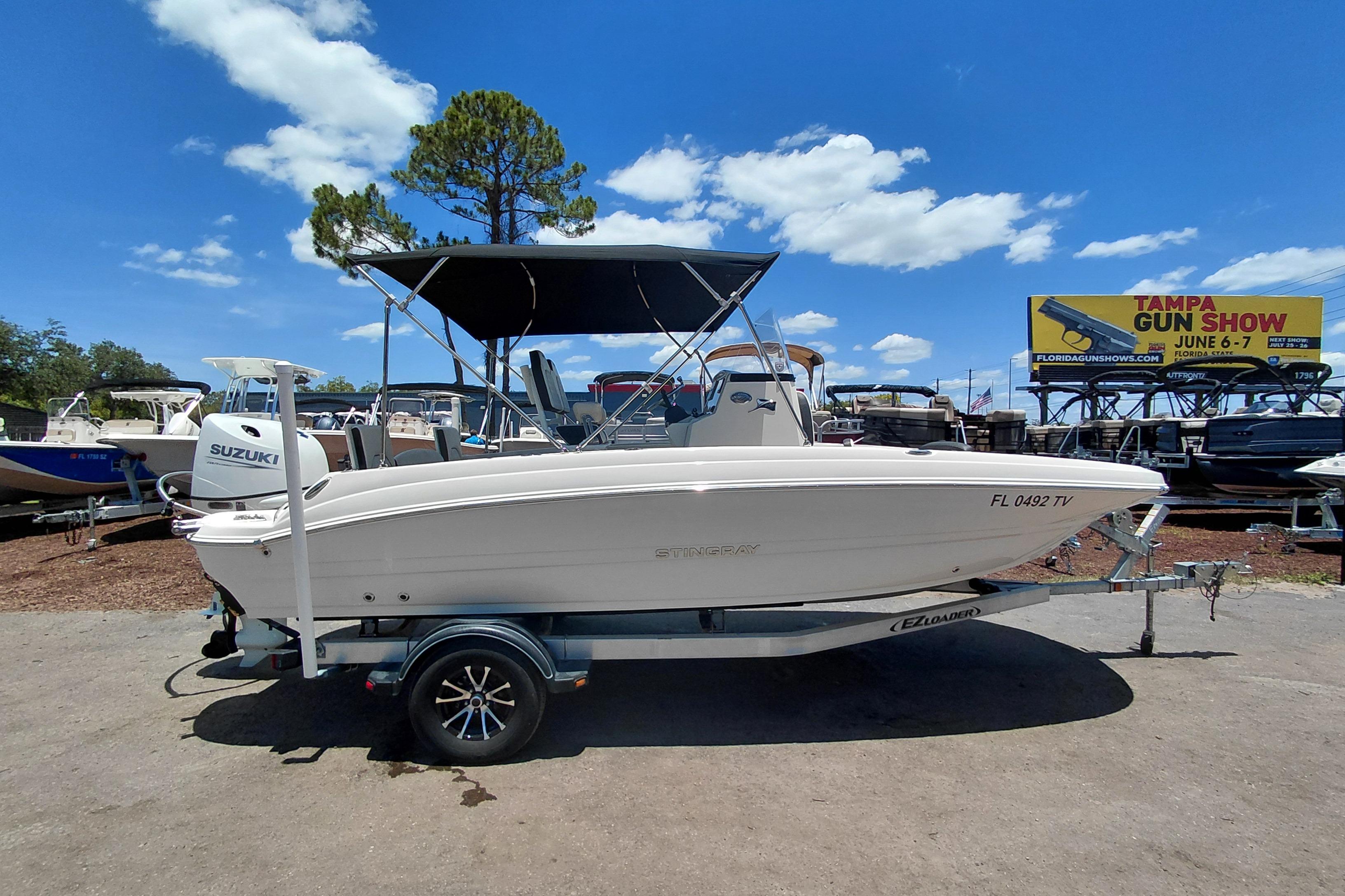 2023 Stingray 206 CC boat on trailer, sunny day, outdoor display.