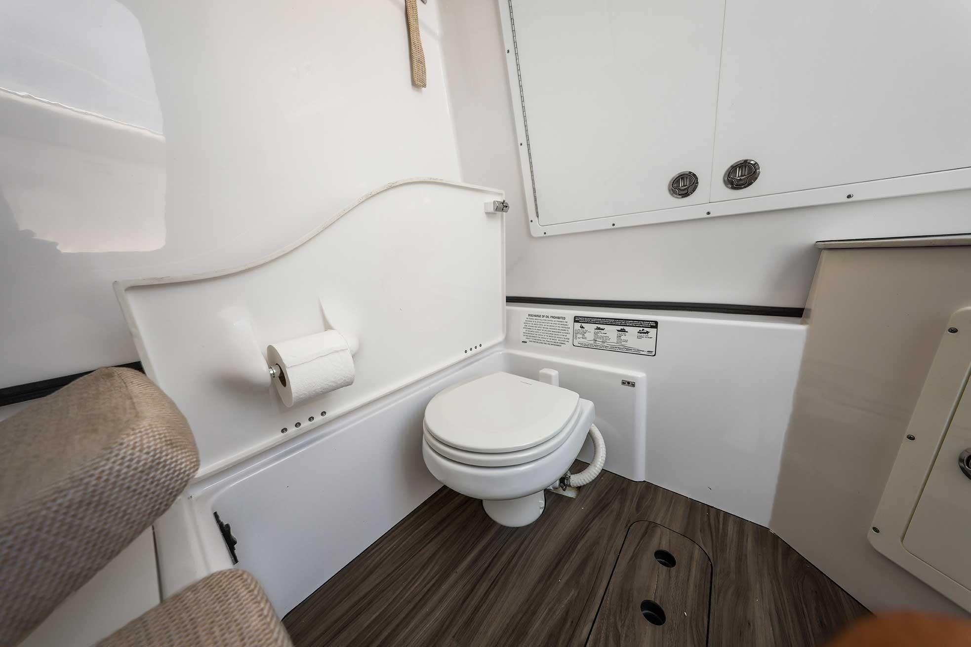 2024 Sportsman Open 352 Center Console boat bathroom interior with toilet and storage.