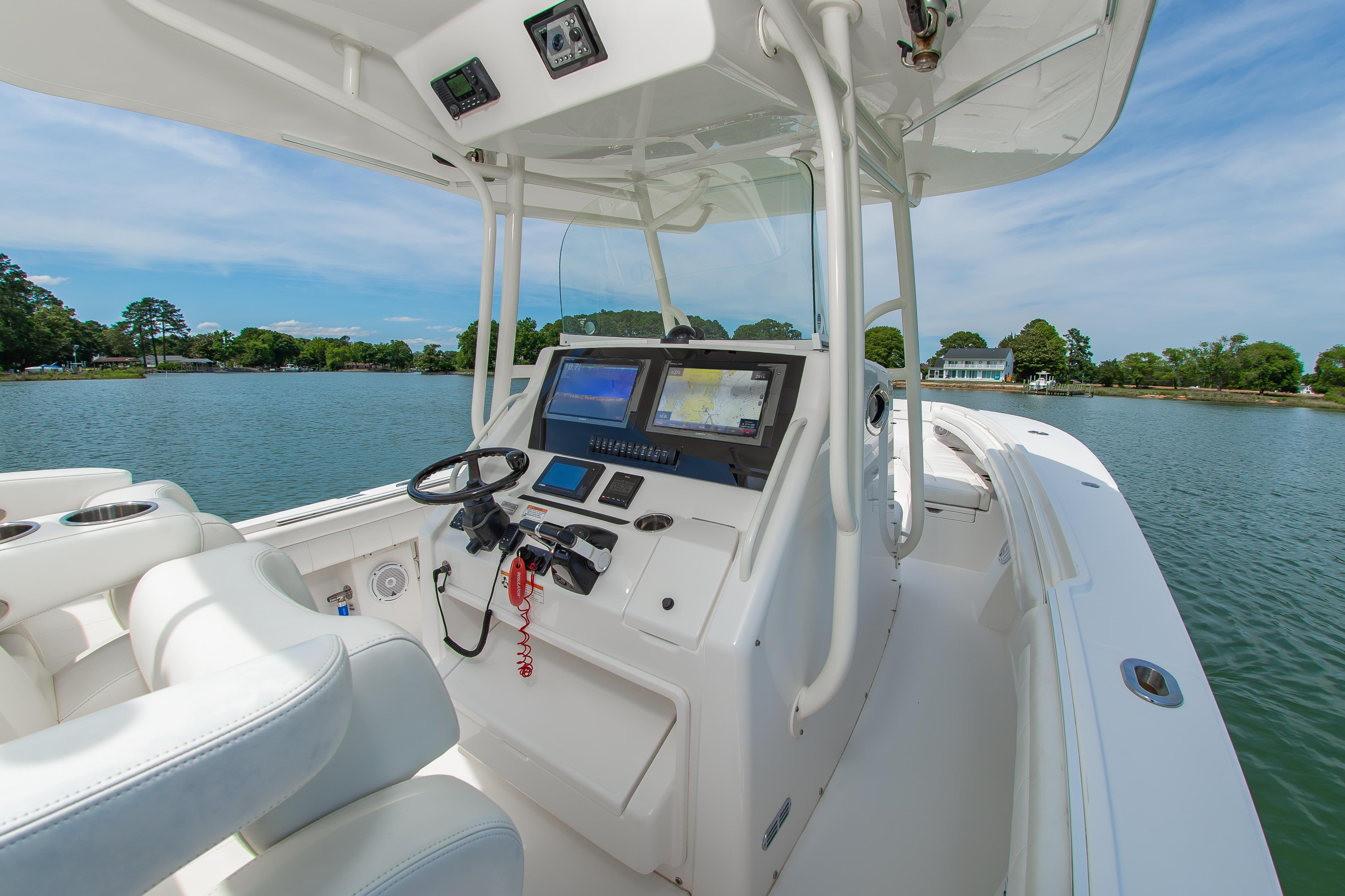 2019 Regulator 31 boat cockpit with navigation system on a calm lake.