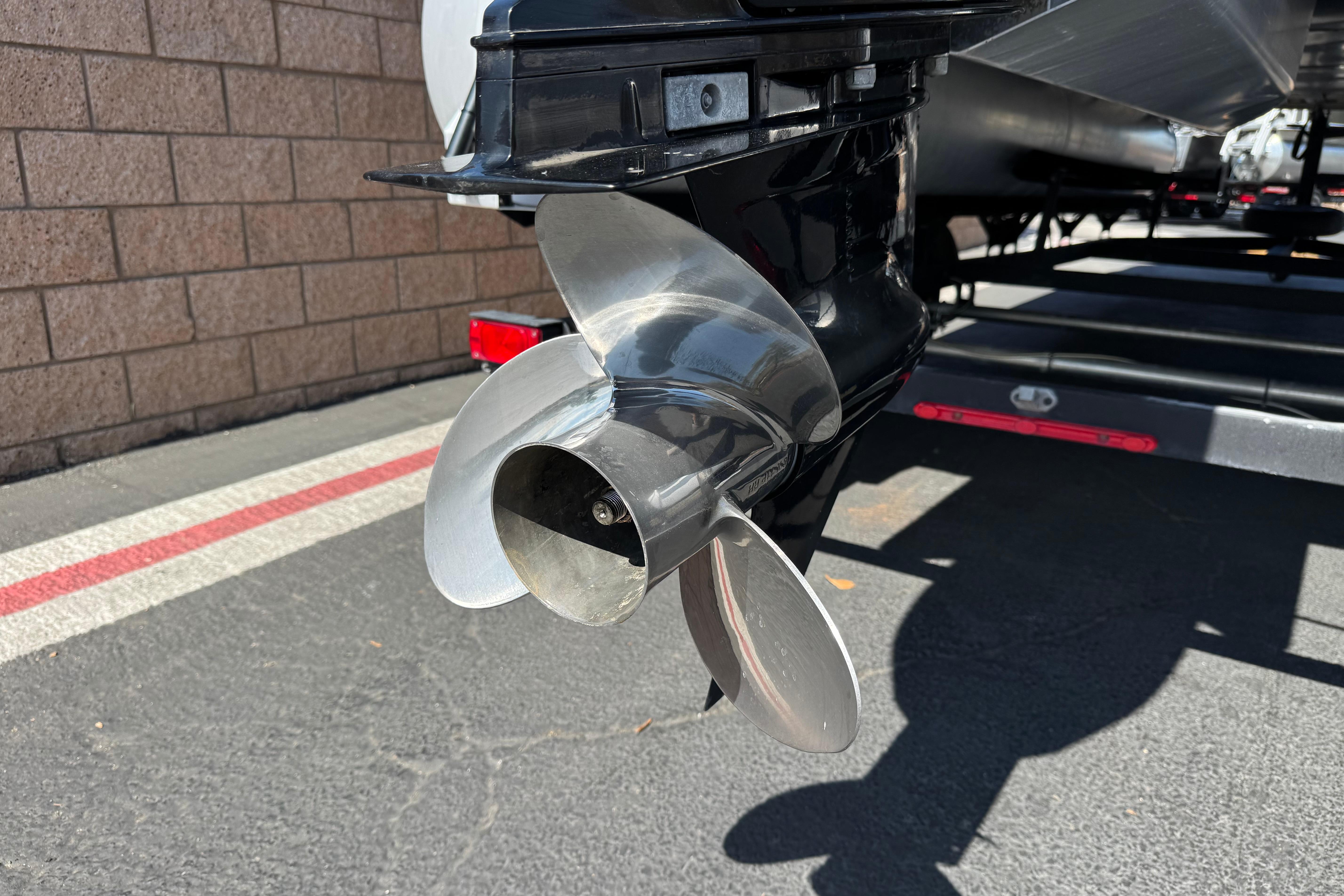 Close-up of a 2018 Sun Tracker SportFish 22 DLX boat propeller on a trailer.