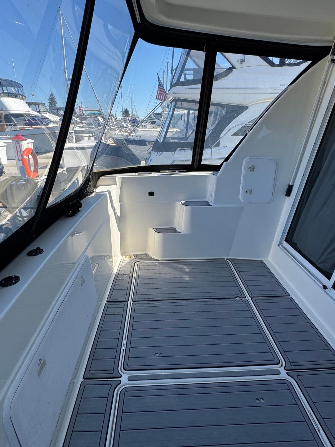 2003 Meridian 381 Sedan yacht deck with modern design and marina view.