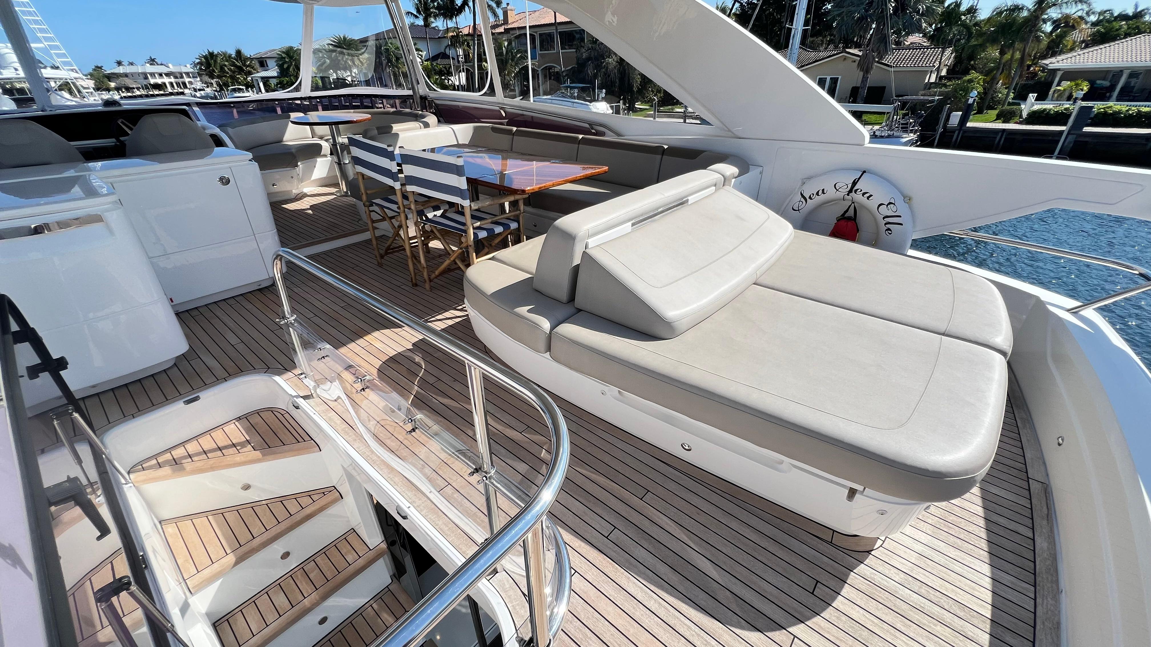 Luxurious 2019 Princess F62 yacht deck with seating and dining area.