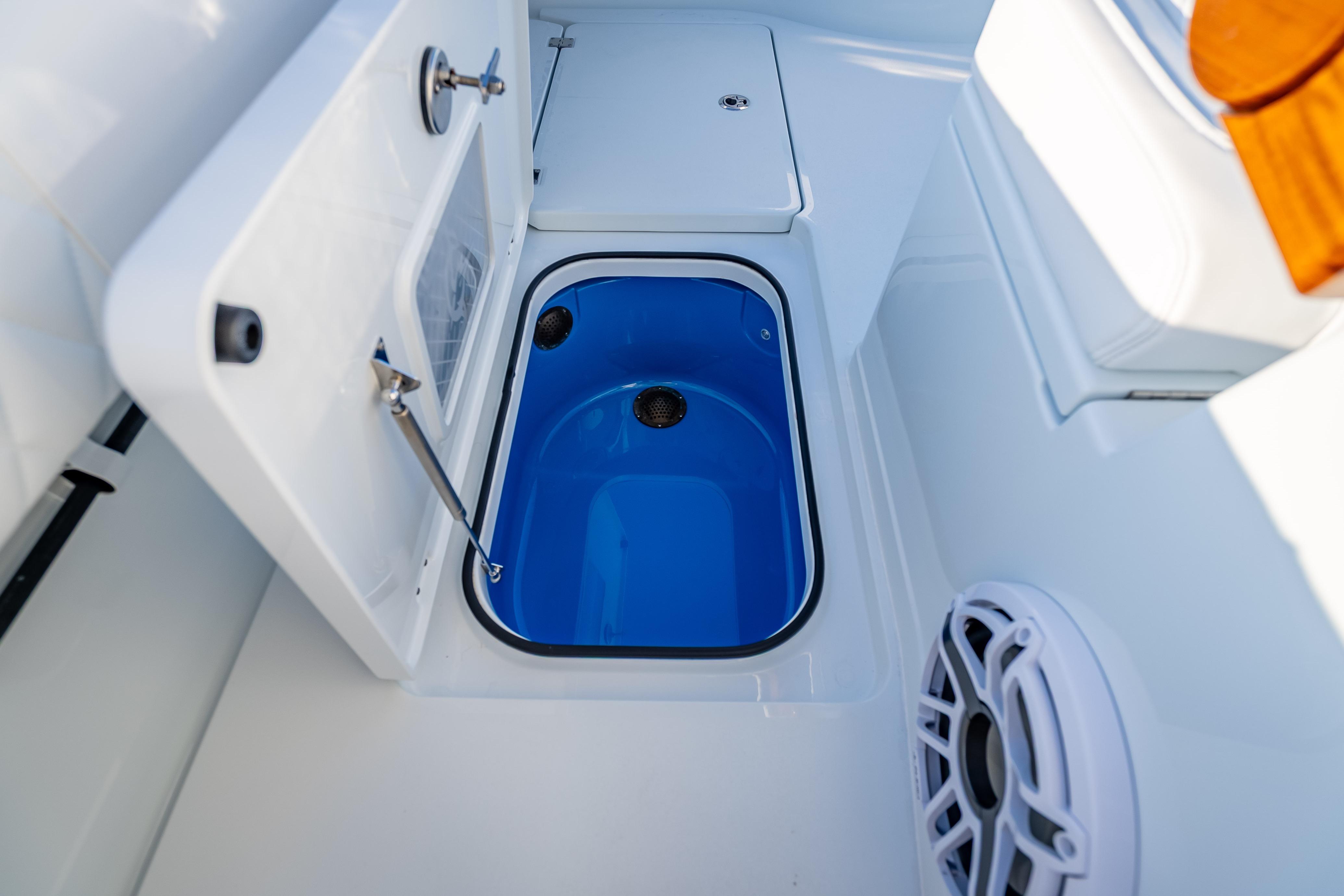 Freeman 35 boat interior, featuring a blue livewell and storage compartments, 2026 model.