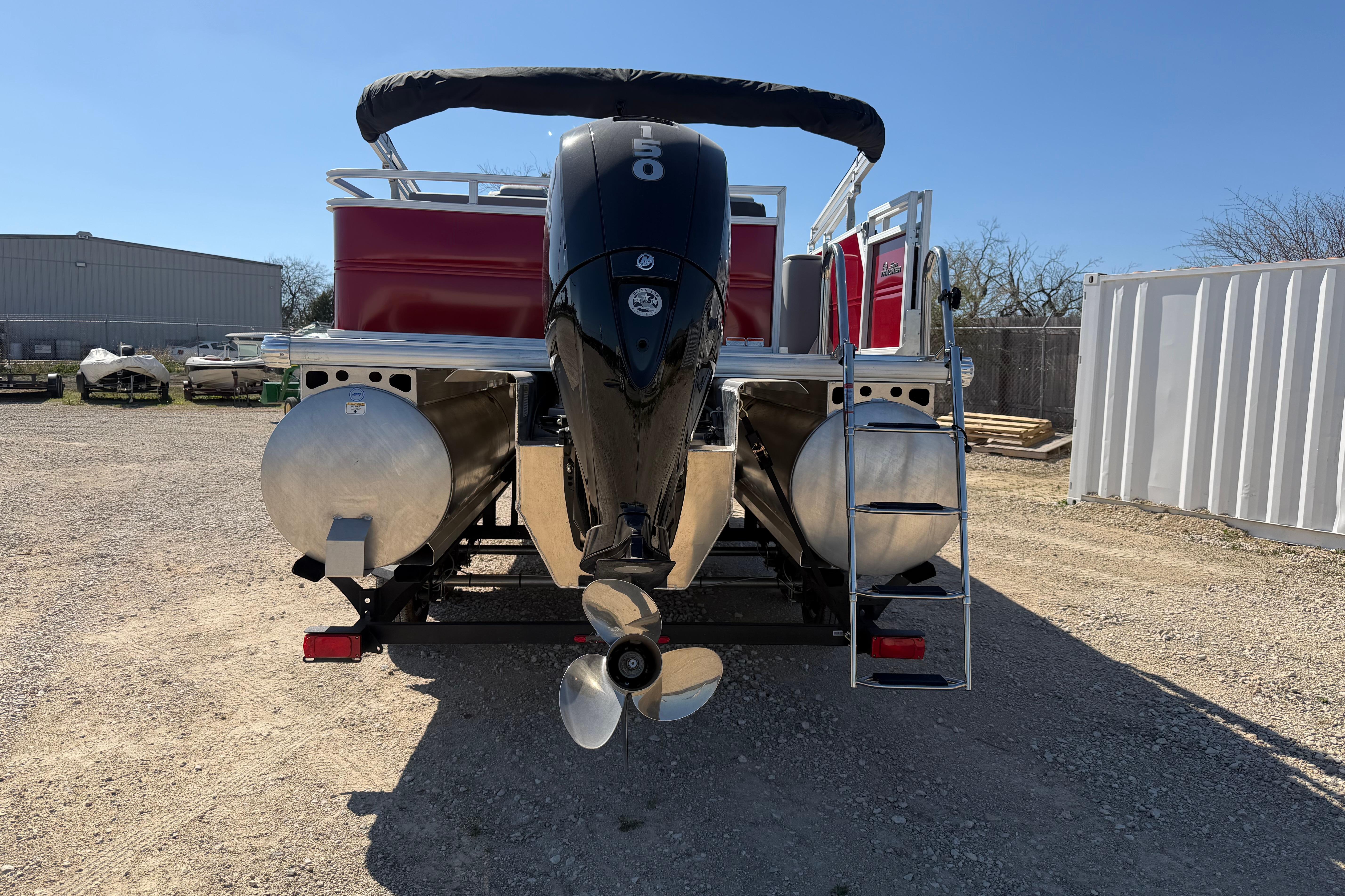 2026 Sun Tracker Party Barge 22 RF XP3 pontoon boat, rear view with motor and ladder.