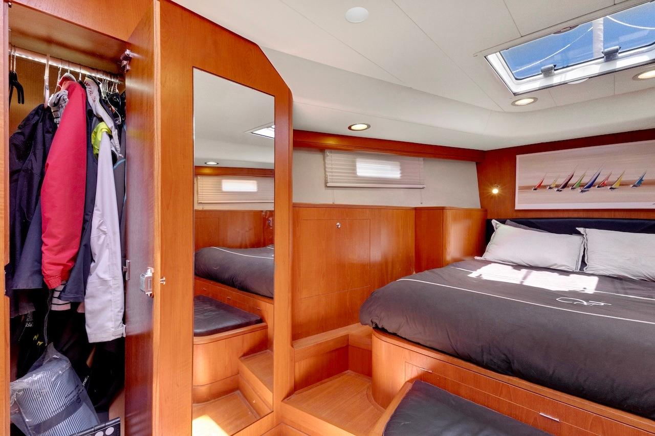 Luxurious cabin interior of 2011 Southerly 57 RS yacht with bed and wardrobe.