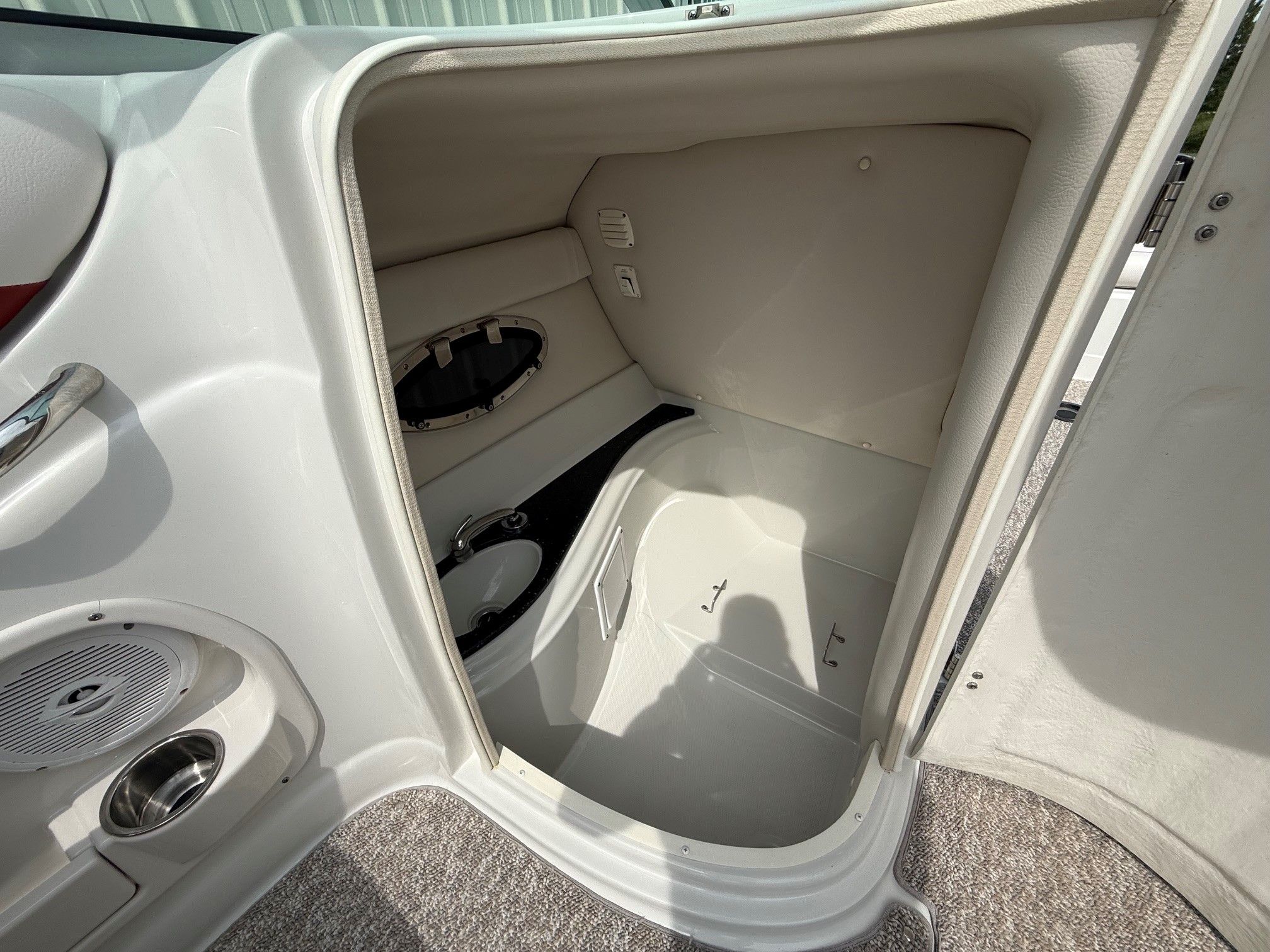 Interior of a 2012 Crownline 252 EX boat with storage space and speaker.