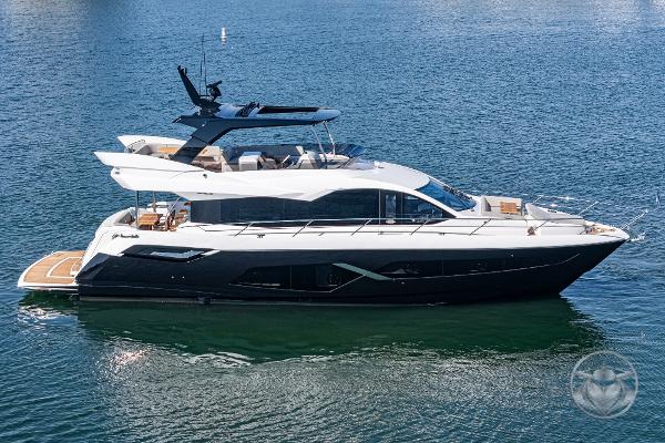 2025 Sunseeker Manhattan 68 yacht on calm water, showcasing sleek design and luxury features.