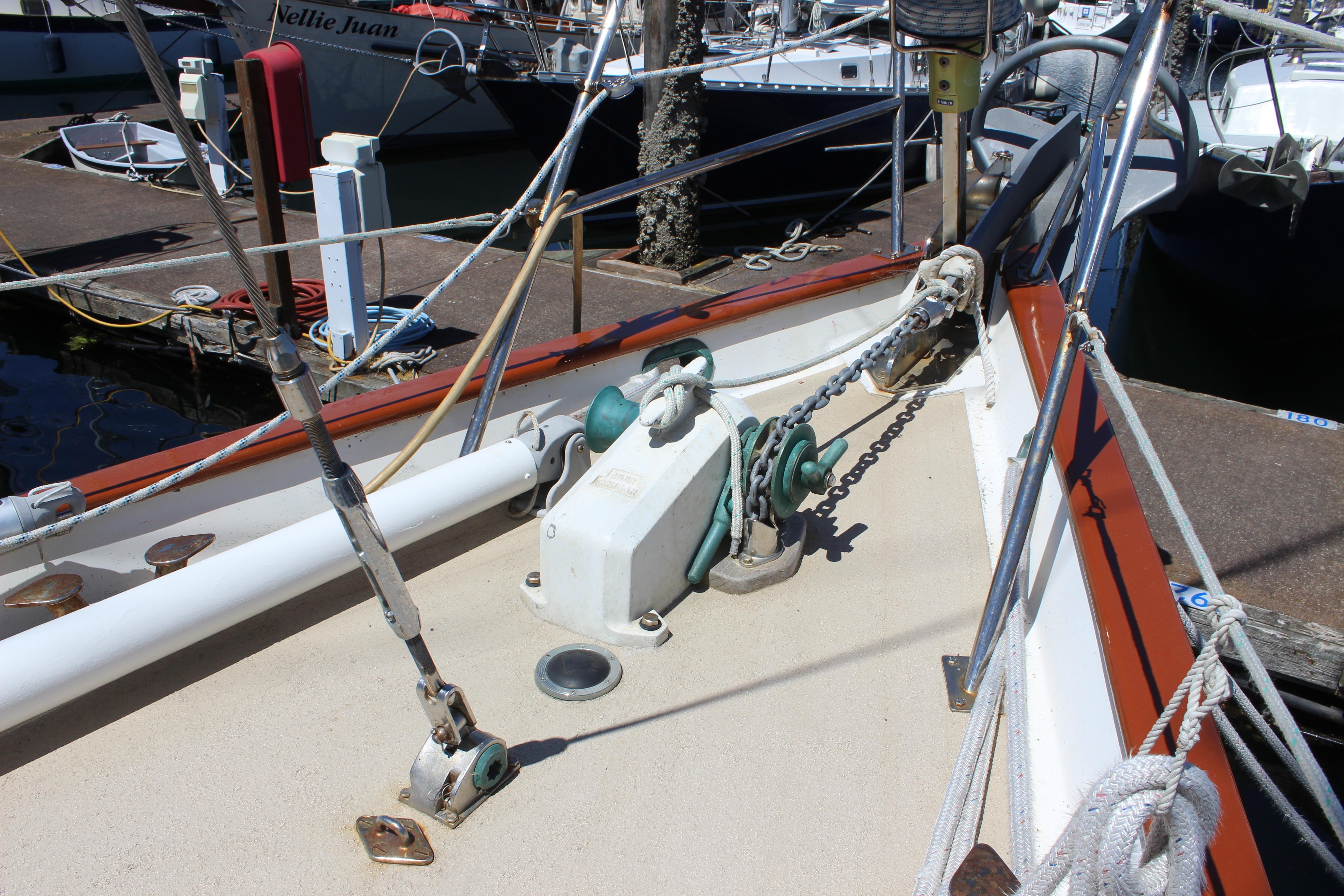 Deck of 1981 Kelly Peterson 46 sailboat with anchor chain and winch system.