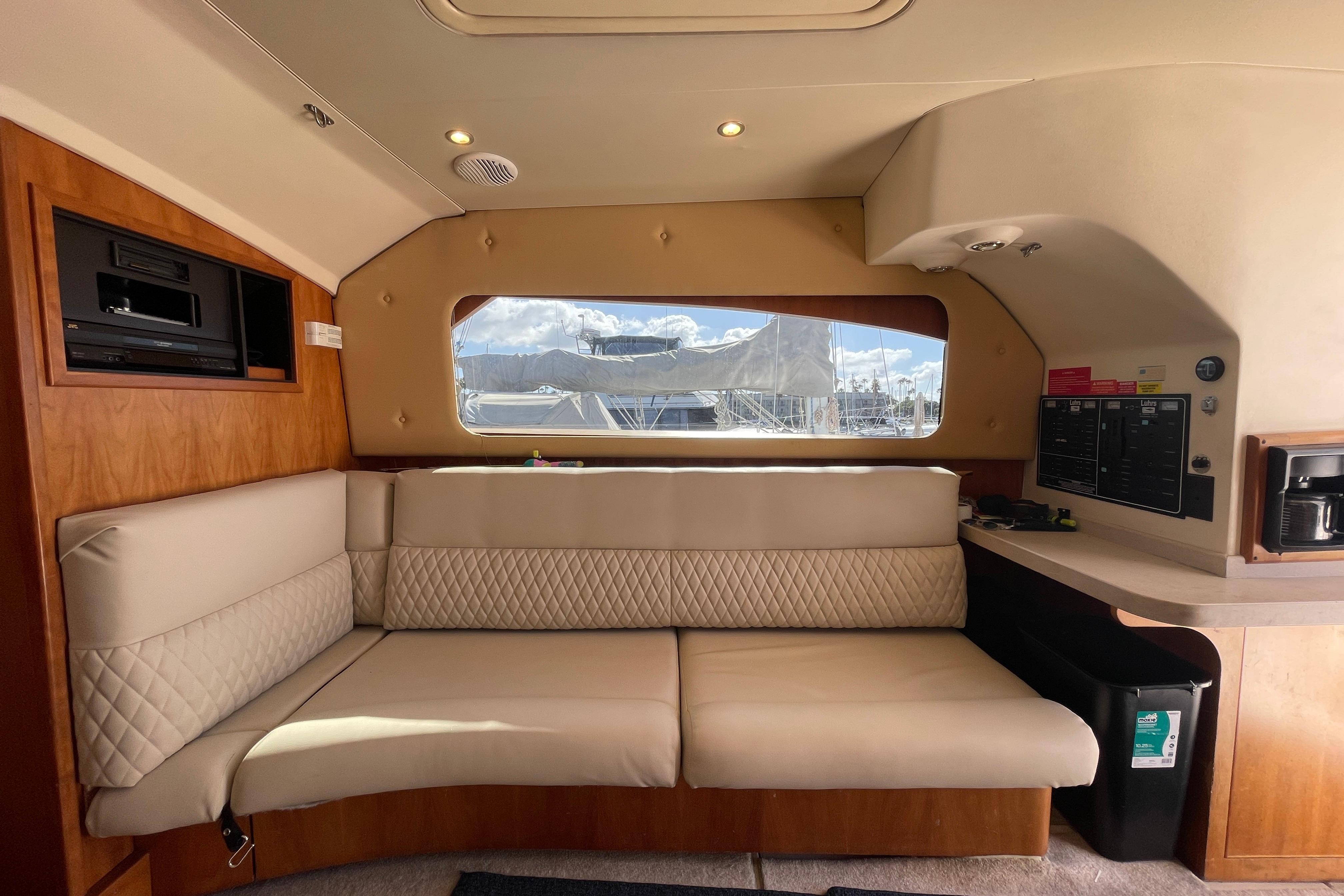 Interior of 2003 Luhrs 34 Convertible yacht with beige seating and wood accents.