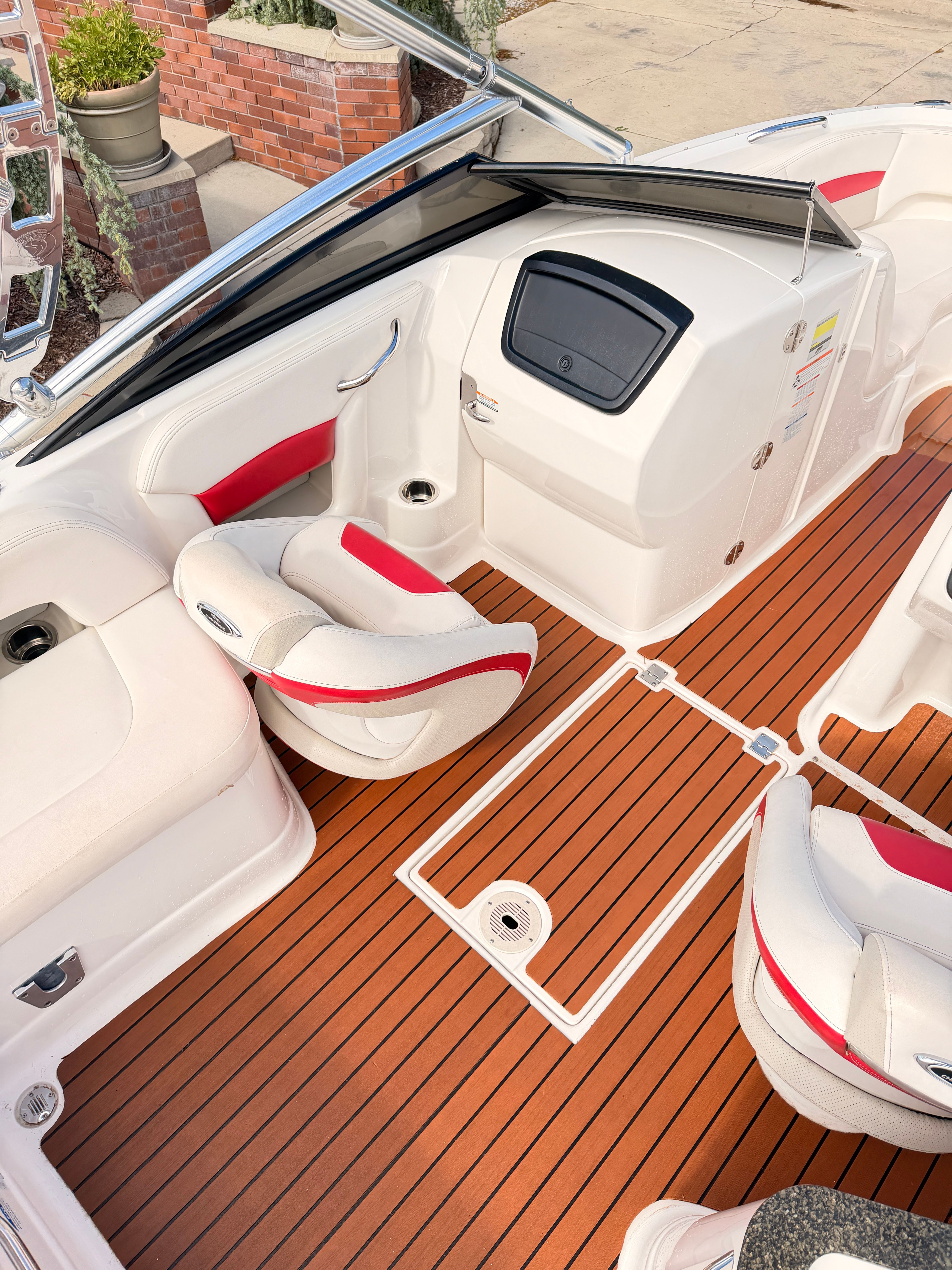 The image shows the cockpit of a 2008 Chaparral Sunesta 224 with white and red seating.