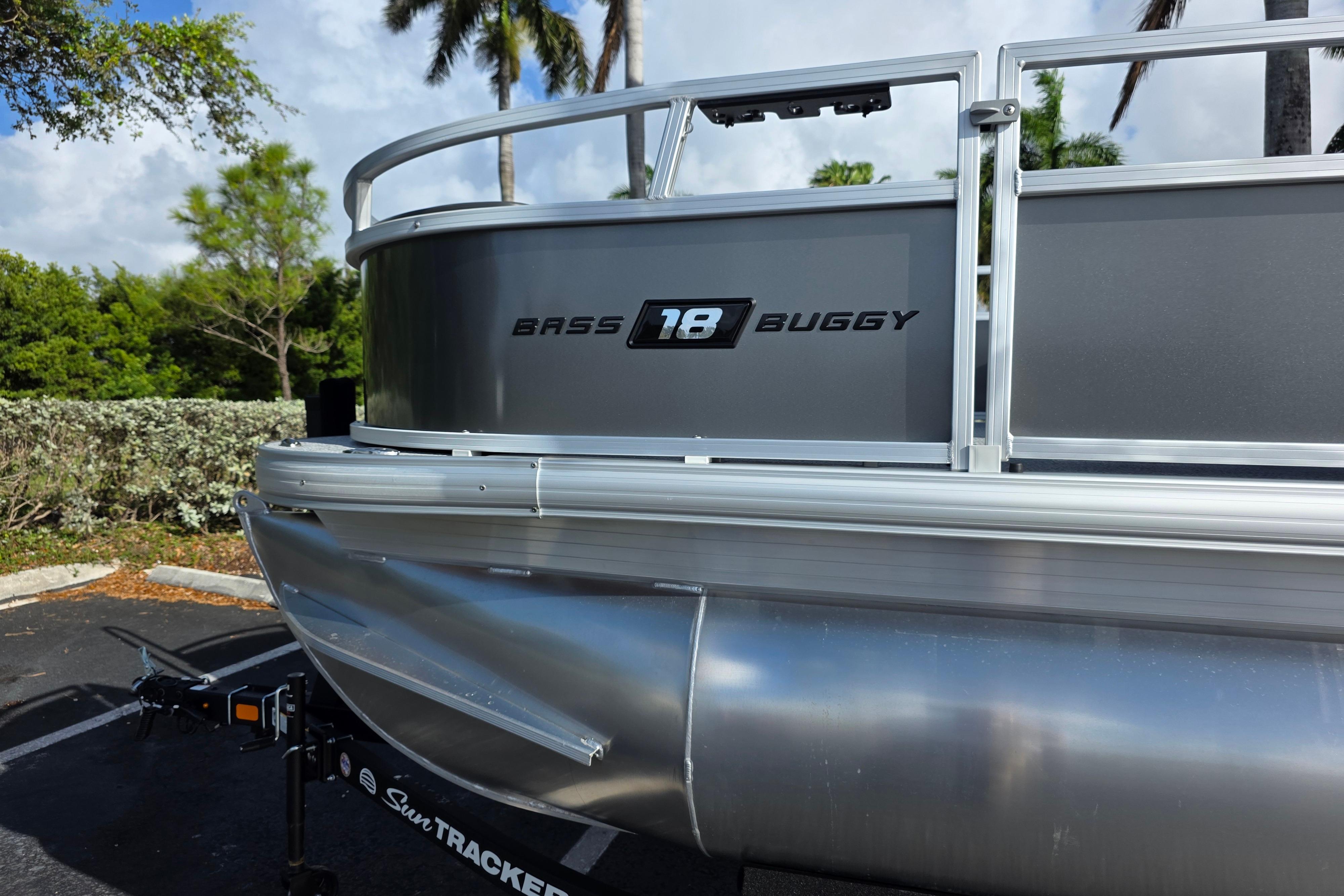 2026 Sun Tracker Bass Buggy 16 XL Select pontoon boat, parked outdoors.