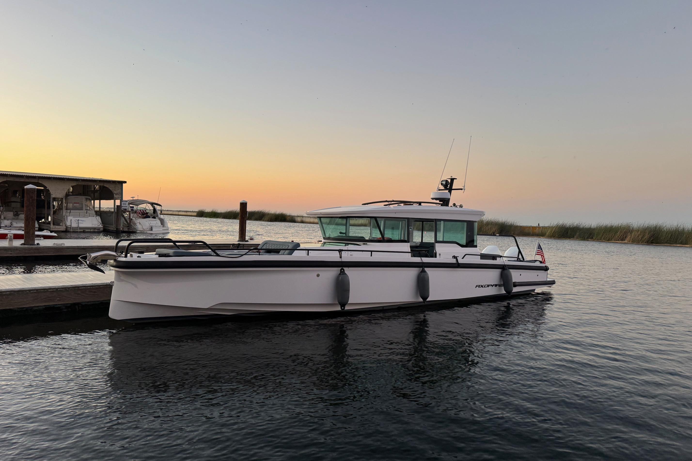 2022 Axopar Brabus 37 XC Cross Cabin boat docked at sunset.