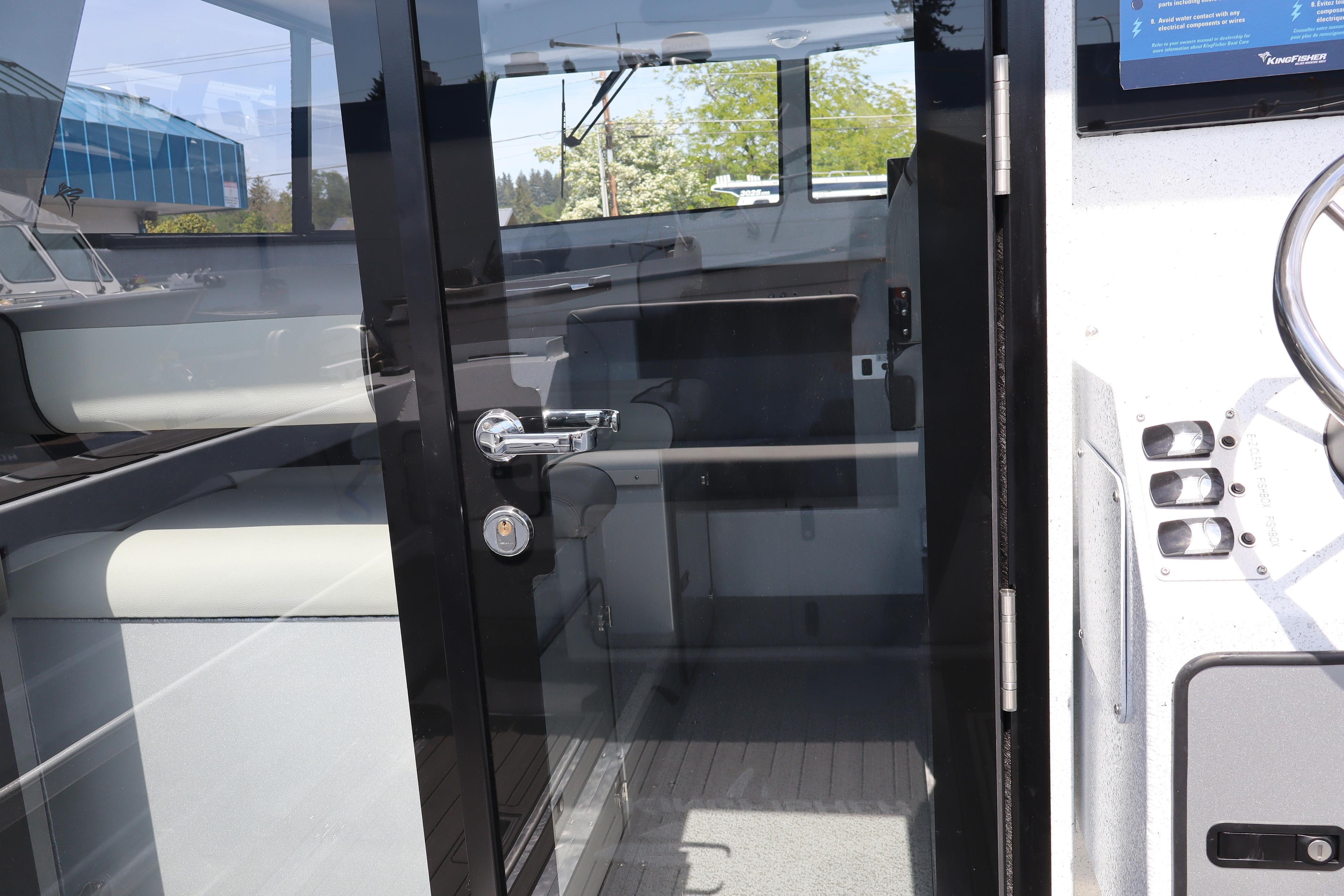 Interior view of 2026 KingFisher 25 XAC boat through glass door.